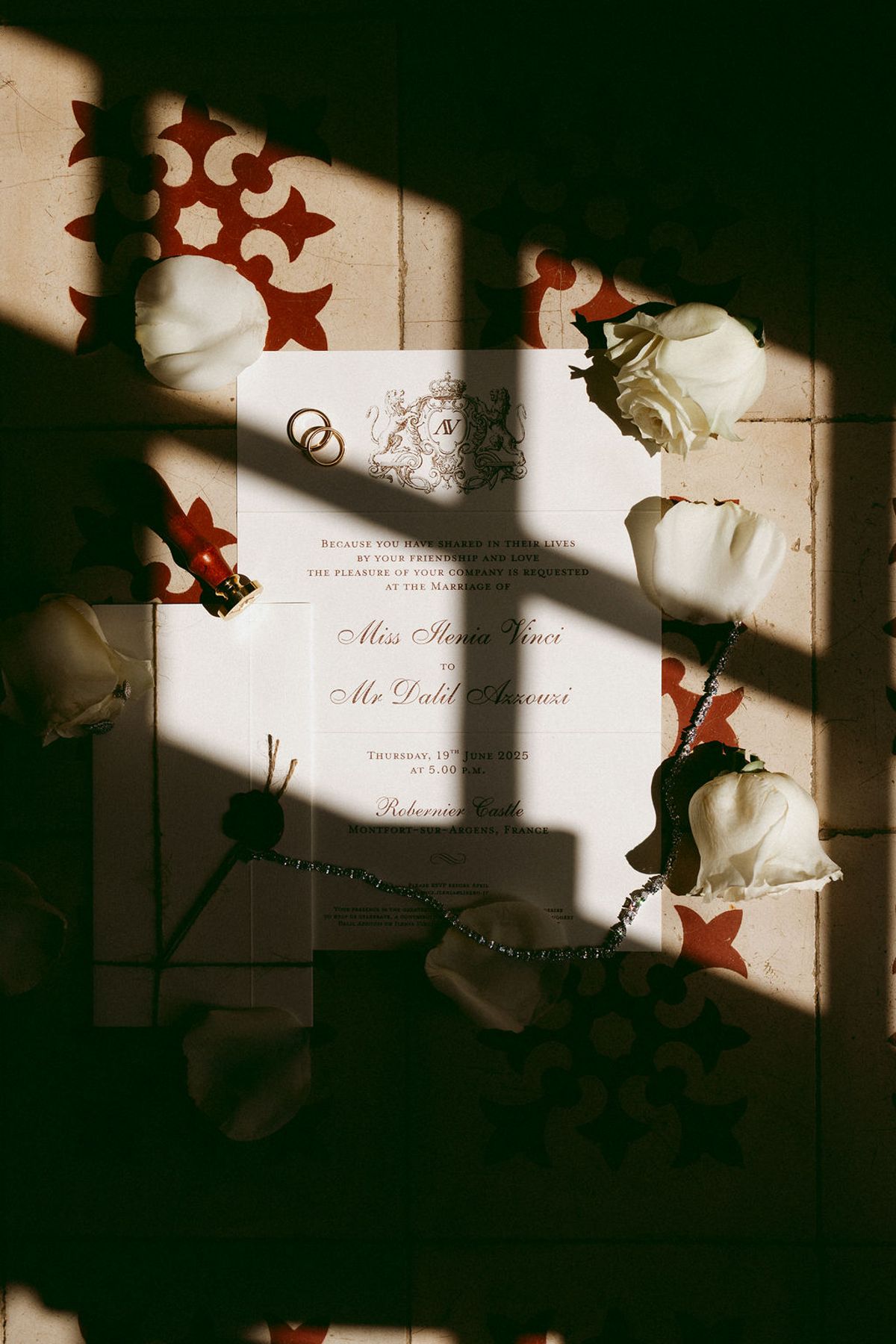 Wedding invitation suite with white roses in dappled light at Château de Robernier