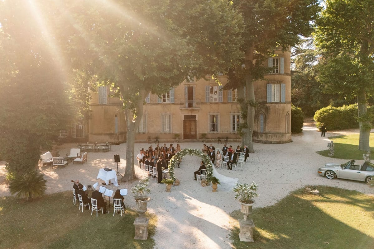 Golden evening light across Château de Robernier during the outdoor ceremony