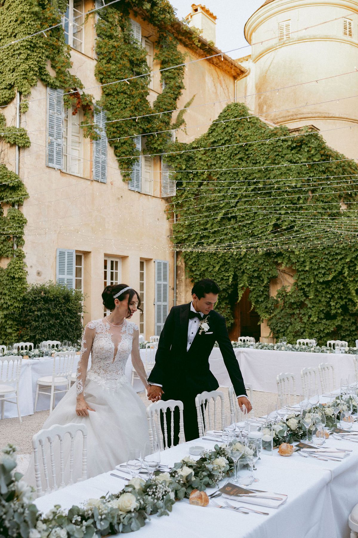 Ilenia and Dalil walking the length of the courtyard banquet table