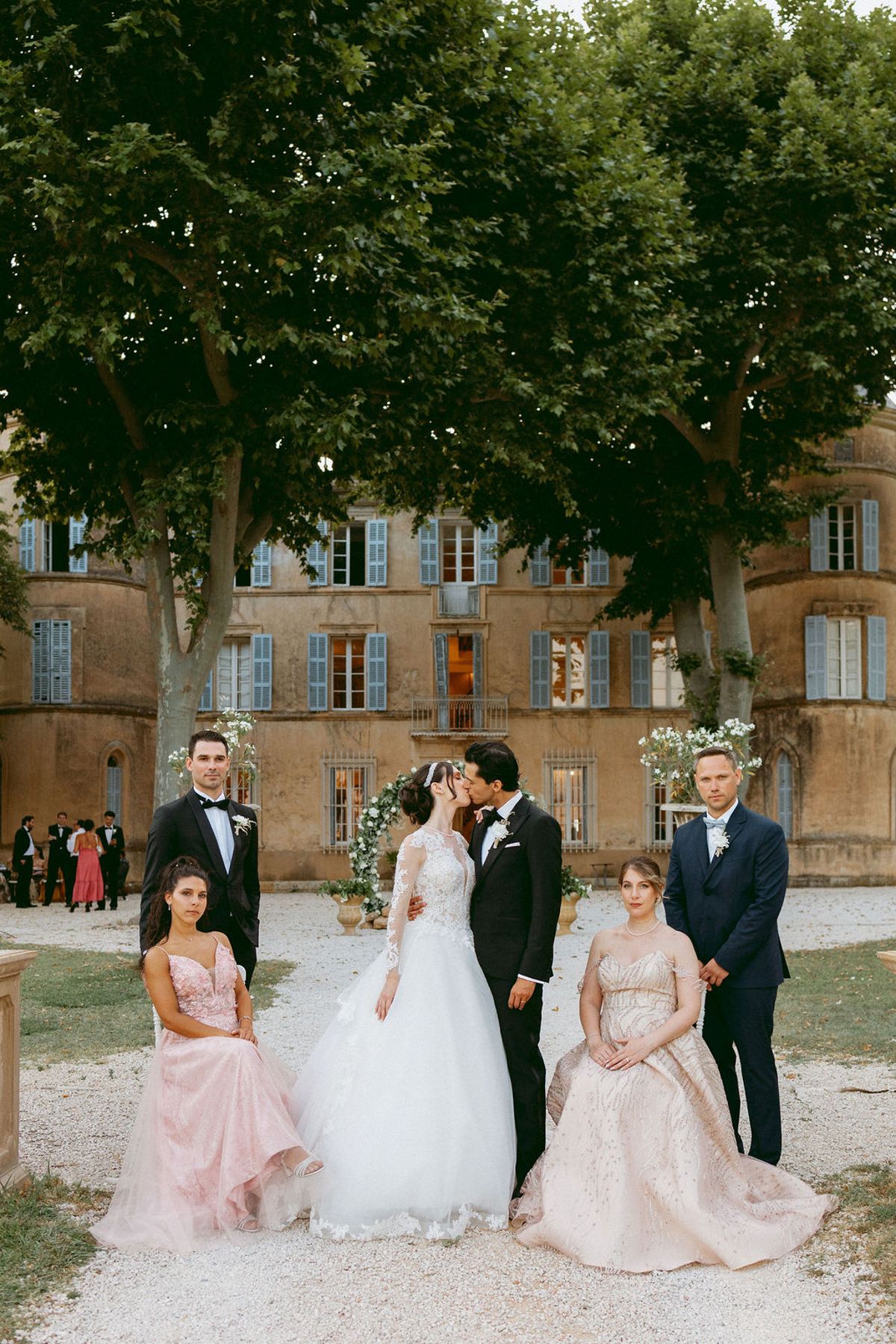 Ilenia and Dalil with their bridal party in front of Château de Robernier