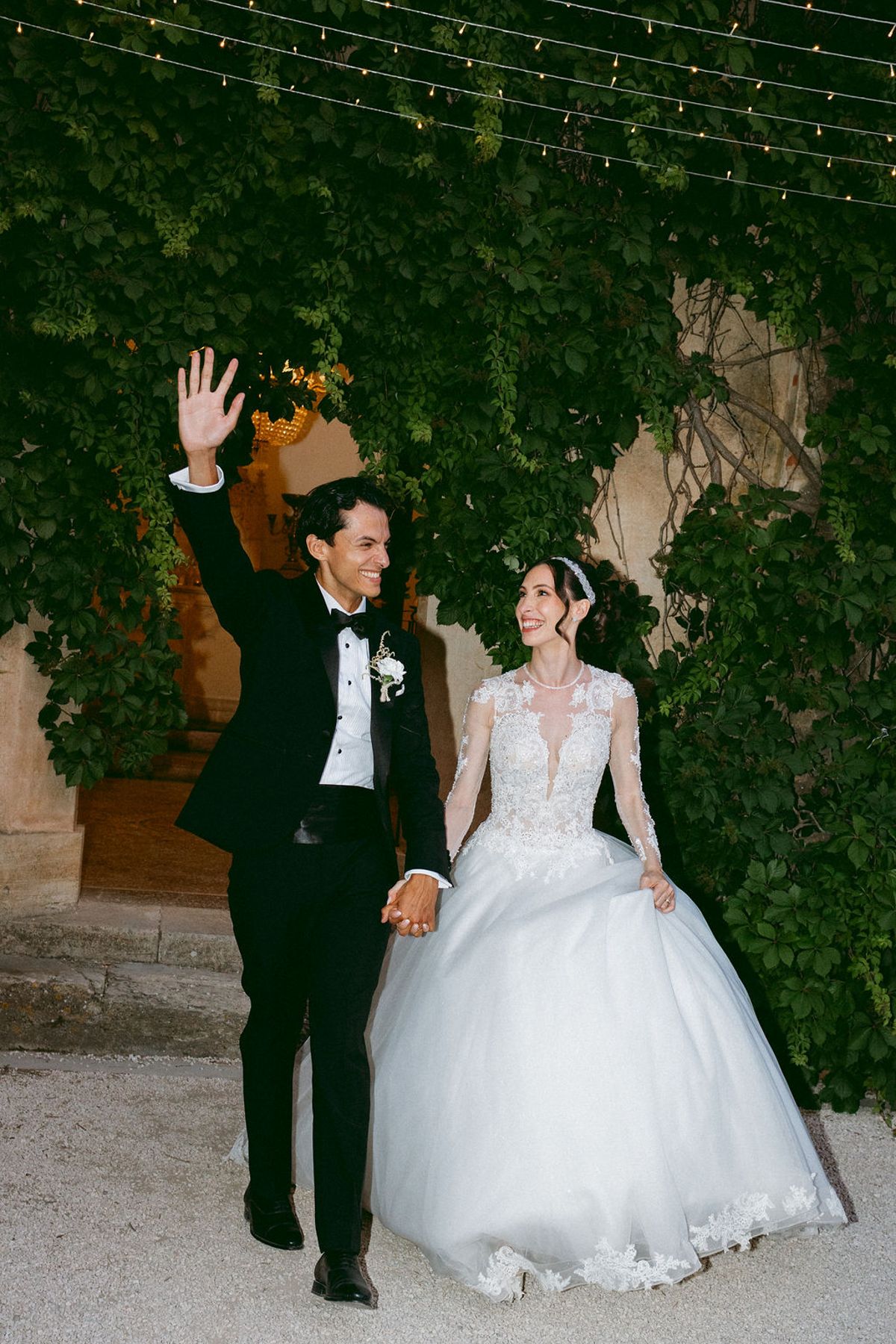 Ilenia and Dalil walking together in the chateau grounds in the evening