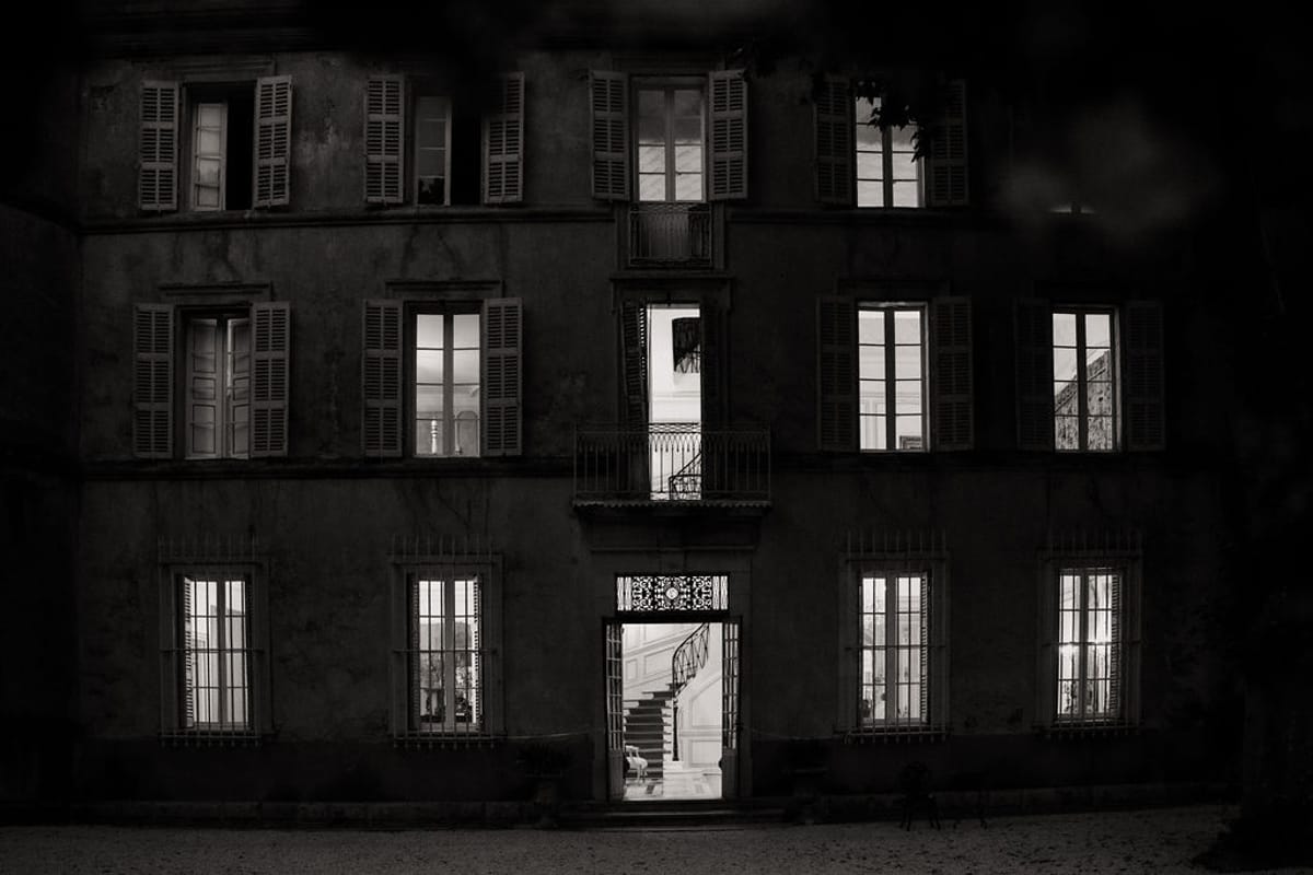 Château de Robernier at night with its windows lit