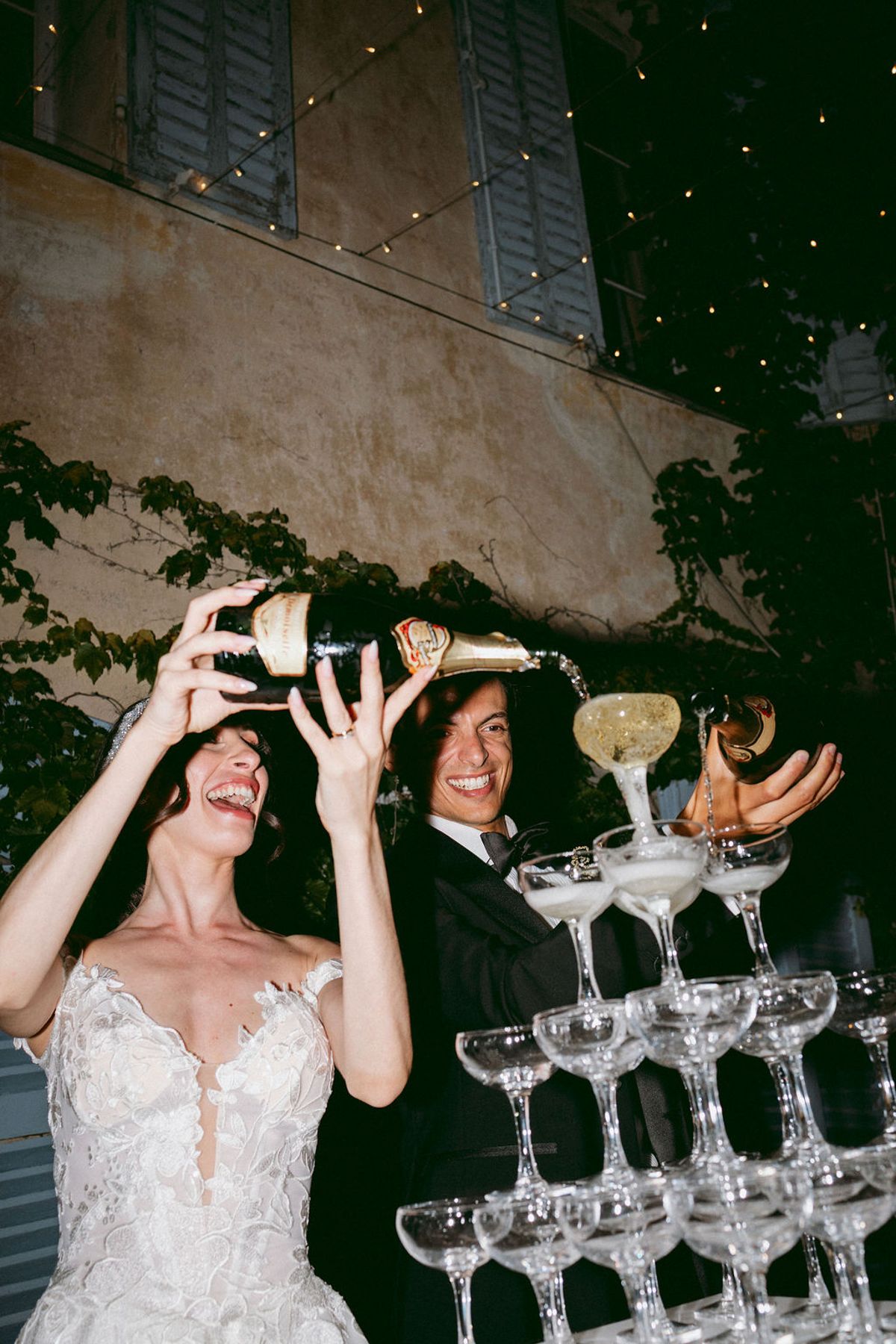 Ilenia and Dalil pouring the champagne tower on the terrace