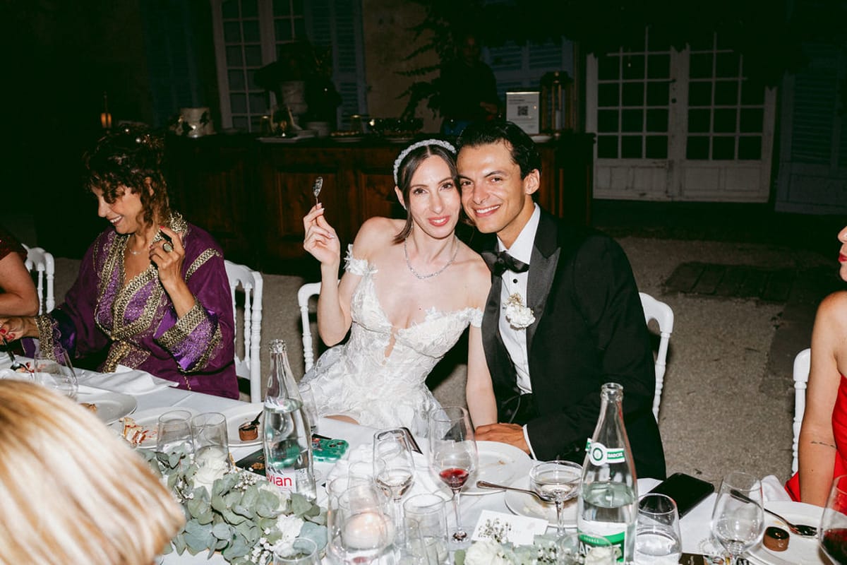 Ilenia and Dalil at the dinner table with their guests