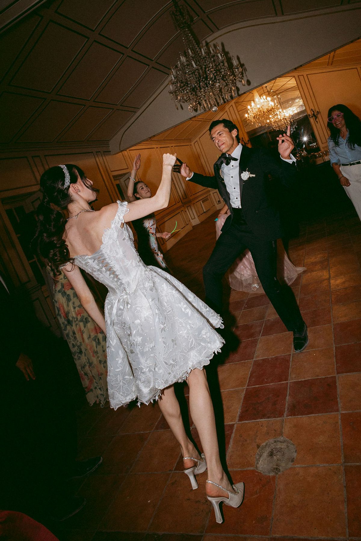 Ilenia and Dalil dancing on the tiled floor of the chateau