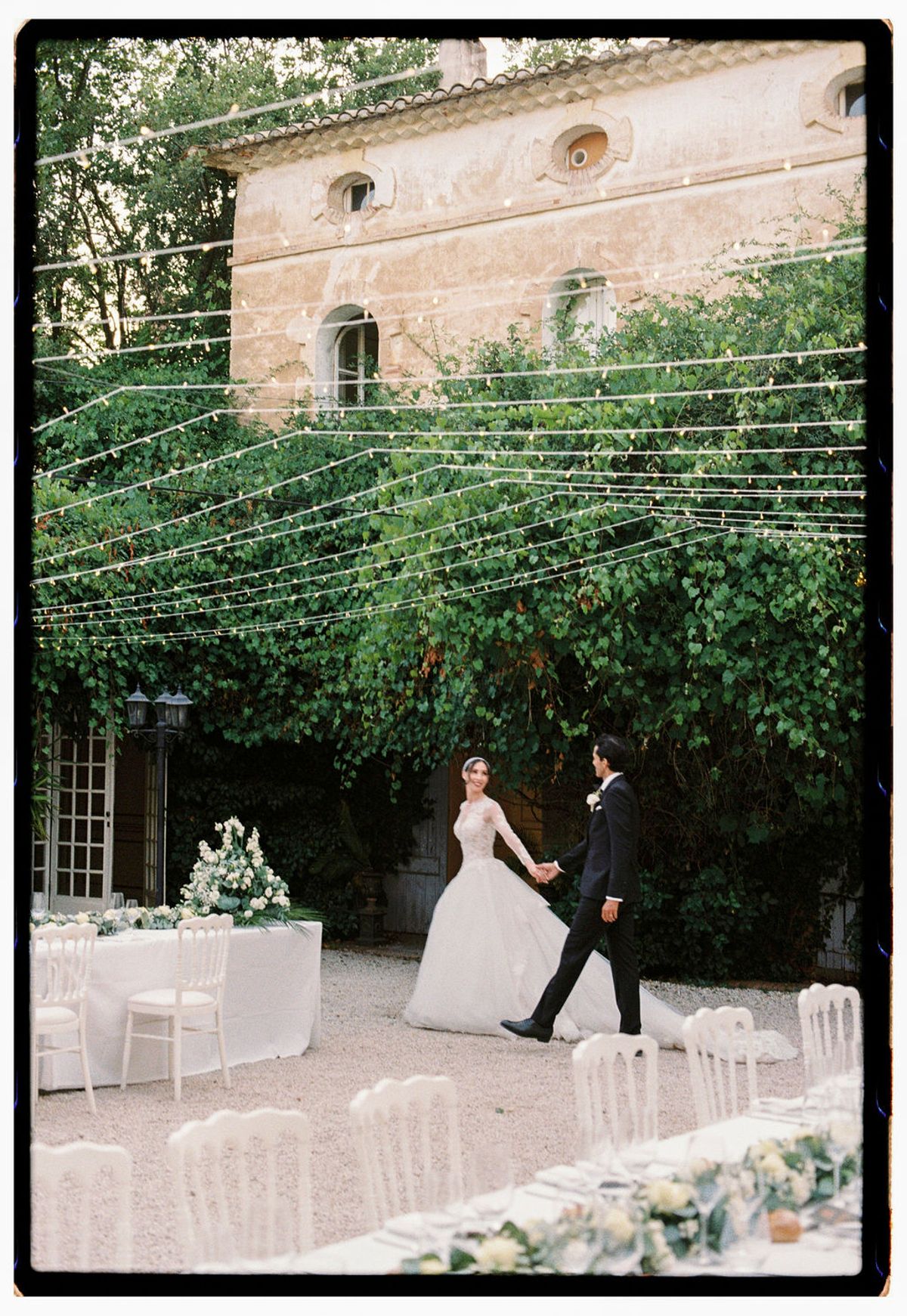Film photograph of Ilenia and Dalil in the courtyard beside the dinner table