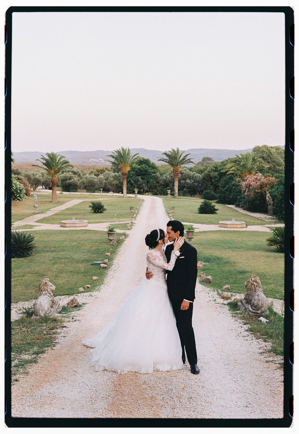 Film photograph of Ilenia and Dalil on the long drive with the valley beyond