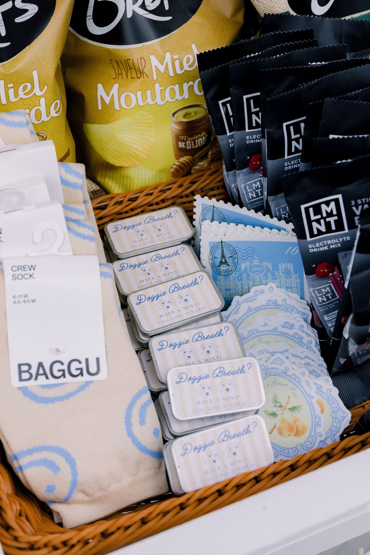 A basket of crisps, mint tins and stamp-shaped cards in the favour cart