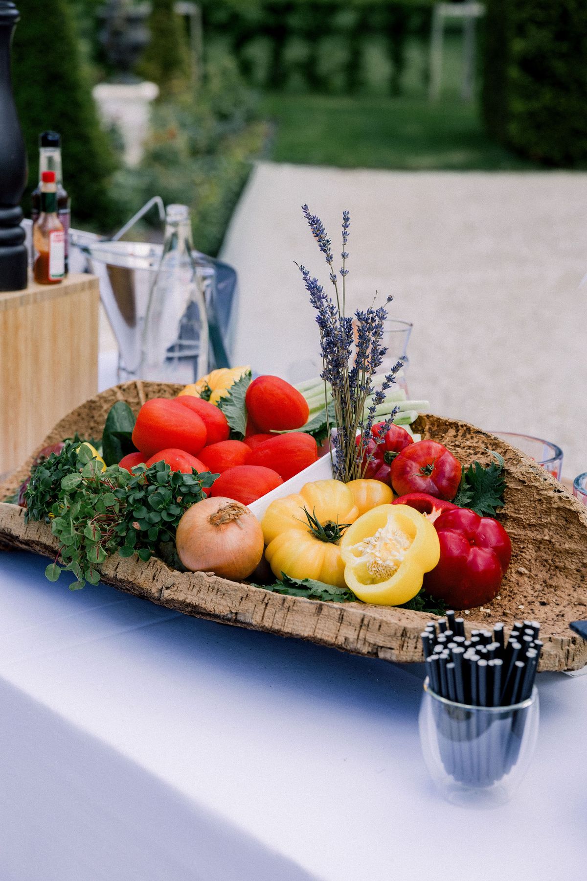 A basket of tomatoes, peppers and lavender on the cocktail bar in the garden