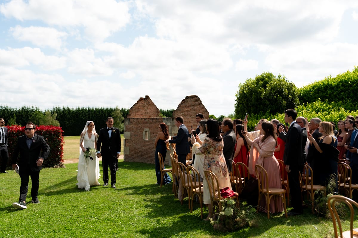 Isadora & Hugo — the ceremony on the lawn with guests seated in rows, spring wedding in Nouvelle-Aquitaine