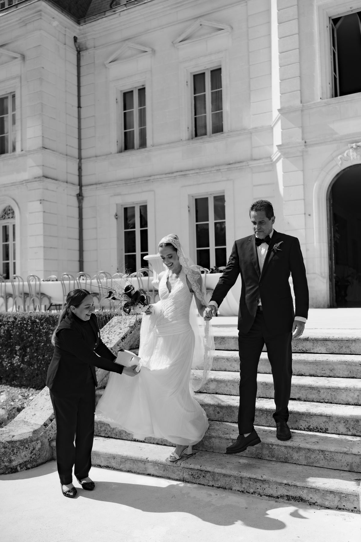 Isadora & Hugo — the couple descending the chateau steps after the ceremony, spring wedding in Nouvelle-Aquitaine