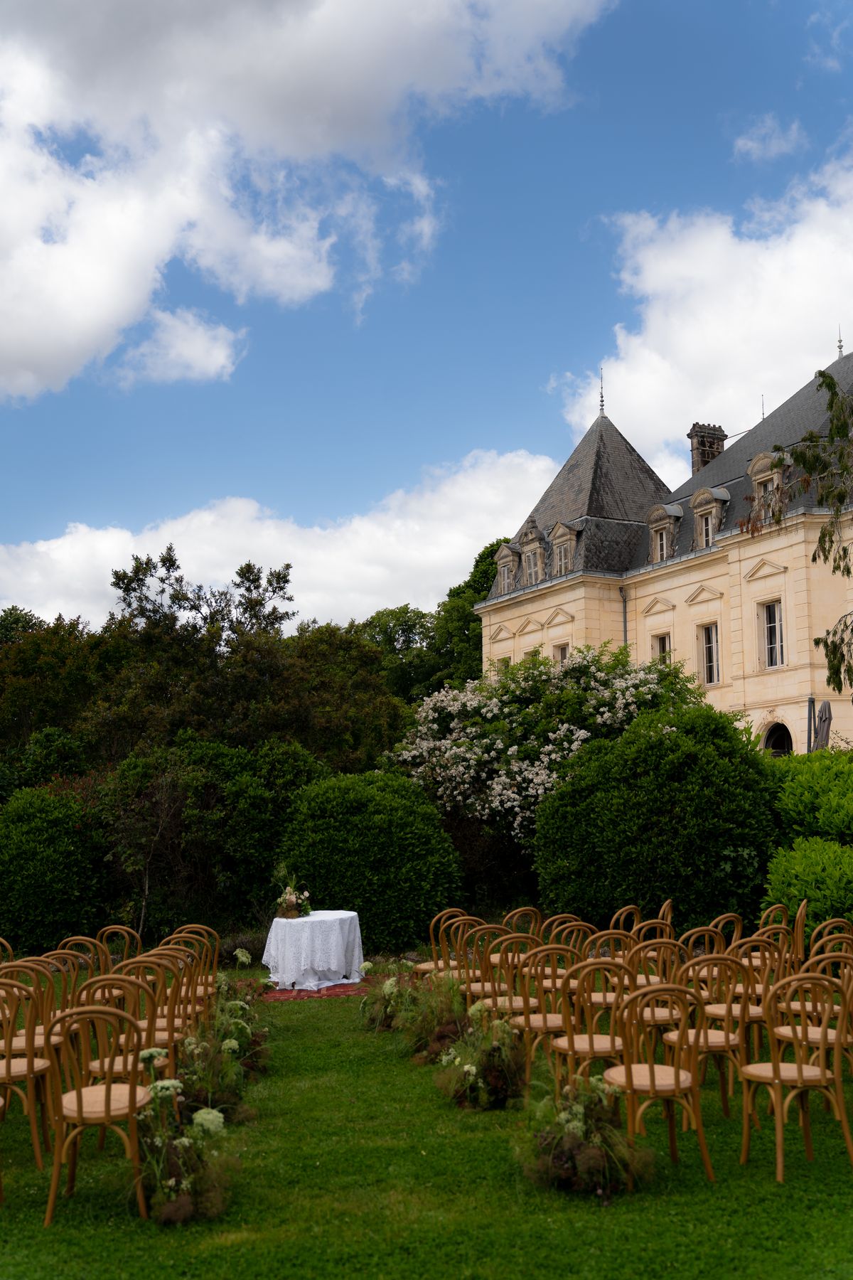 Isadora & Hugo — the ceremony chairs set out on the lawn before the chateau, spring wedding in Nouvelle-Aquitaine