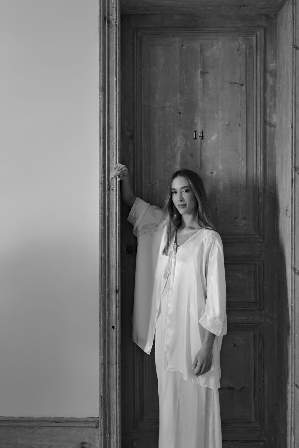 Isadora & Hugo — the bride in a cream silk robe in a doorway, spring wedding in Nouvelle-Aquitaine