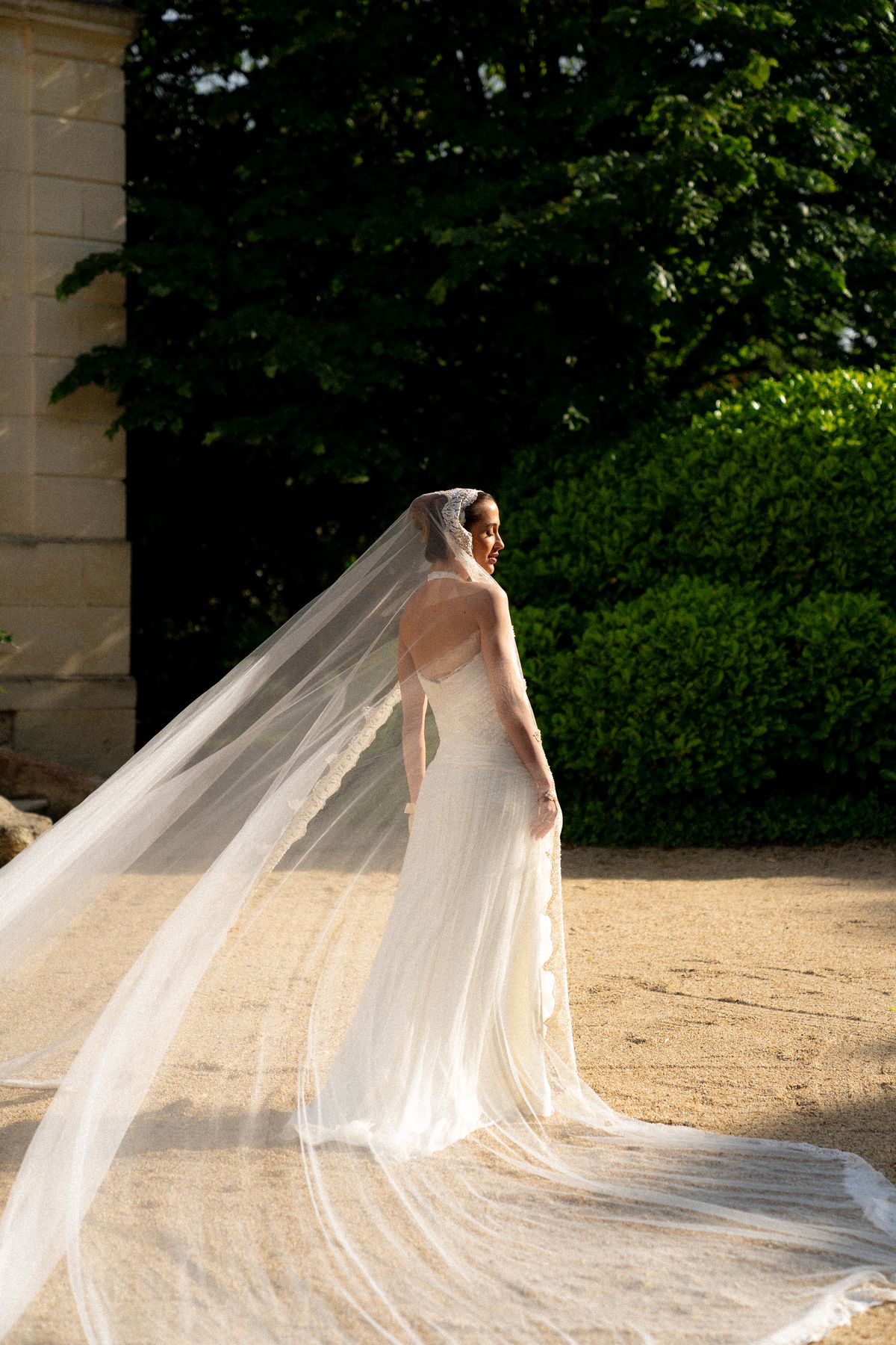 Isadora & Hugo — the bride's veil lifting on the path, spring wedding in Nouvelle-Aquitaine