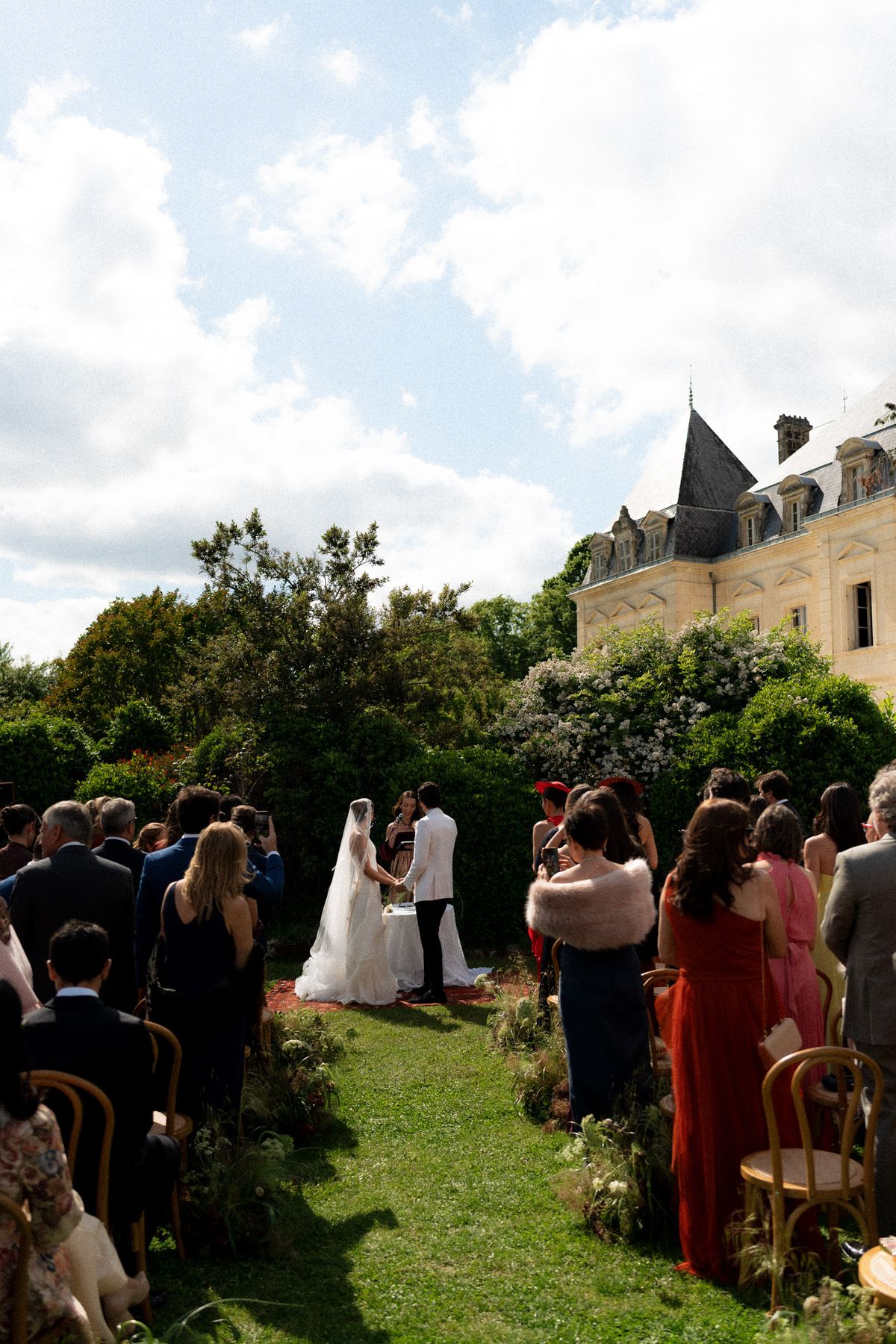 Isadora & Hugo — the ceremony on the lawn with the chateau beyond, spring wedding in Nouvelle-Aquitaine
