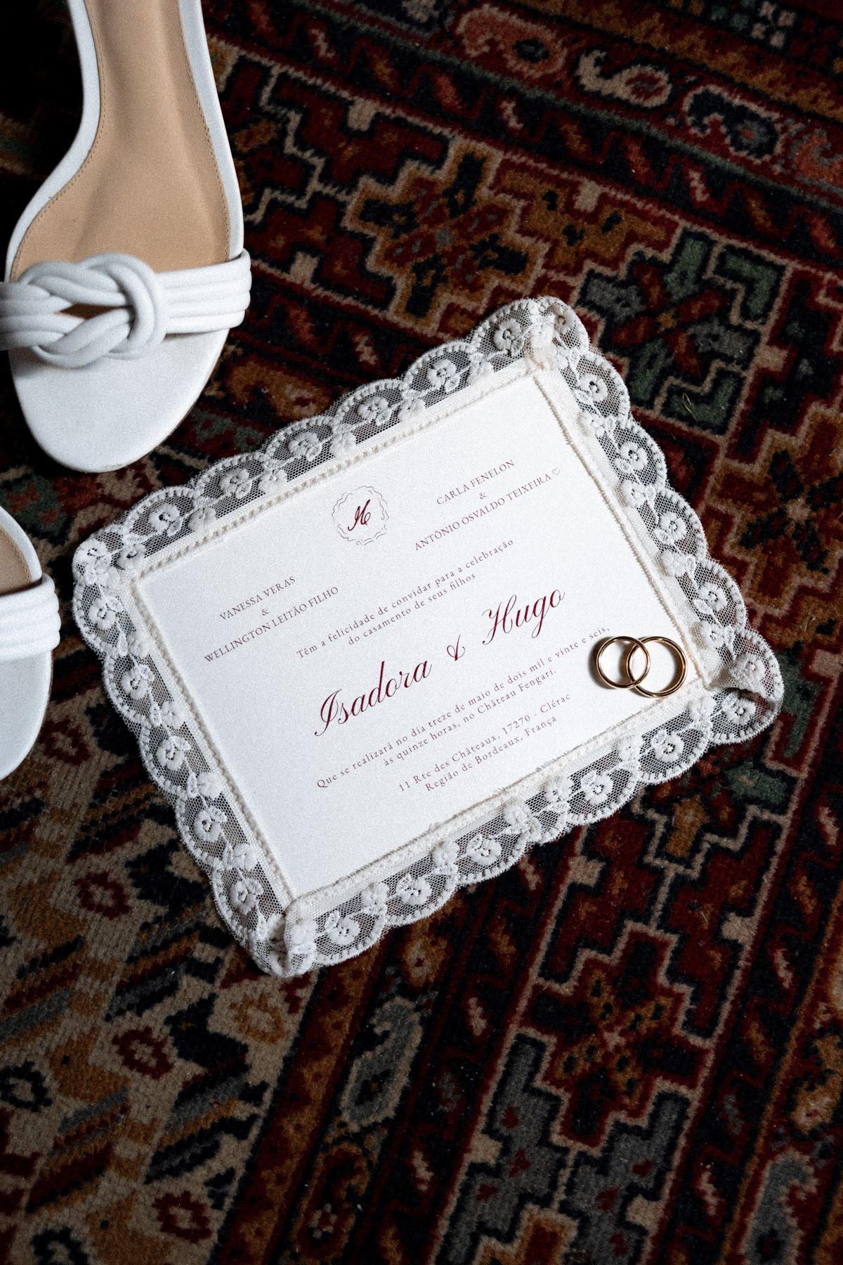Isadora & Hugo — the invitation and the wedding rings laid on a patterned rug, spring wedding in Nouvelle-Aquitaine