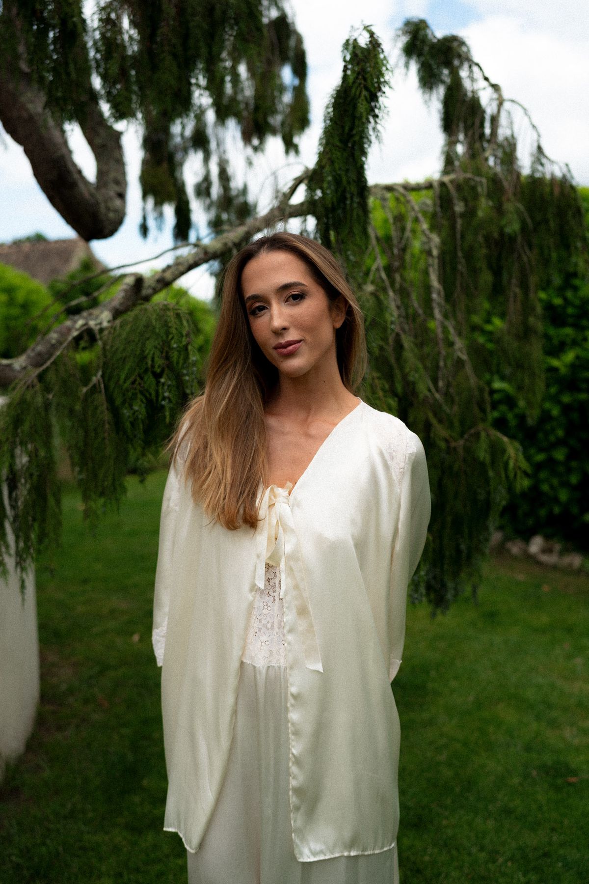 Isadora & Hugo — the bride in a cream silk robe beneath a willow, spring wedding in Nouvelle-Aquitaine