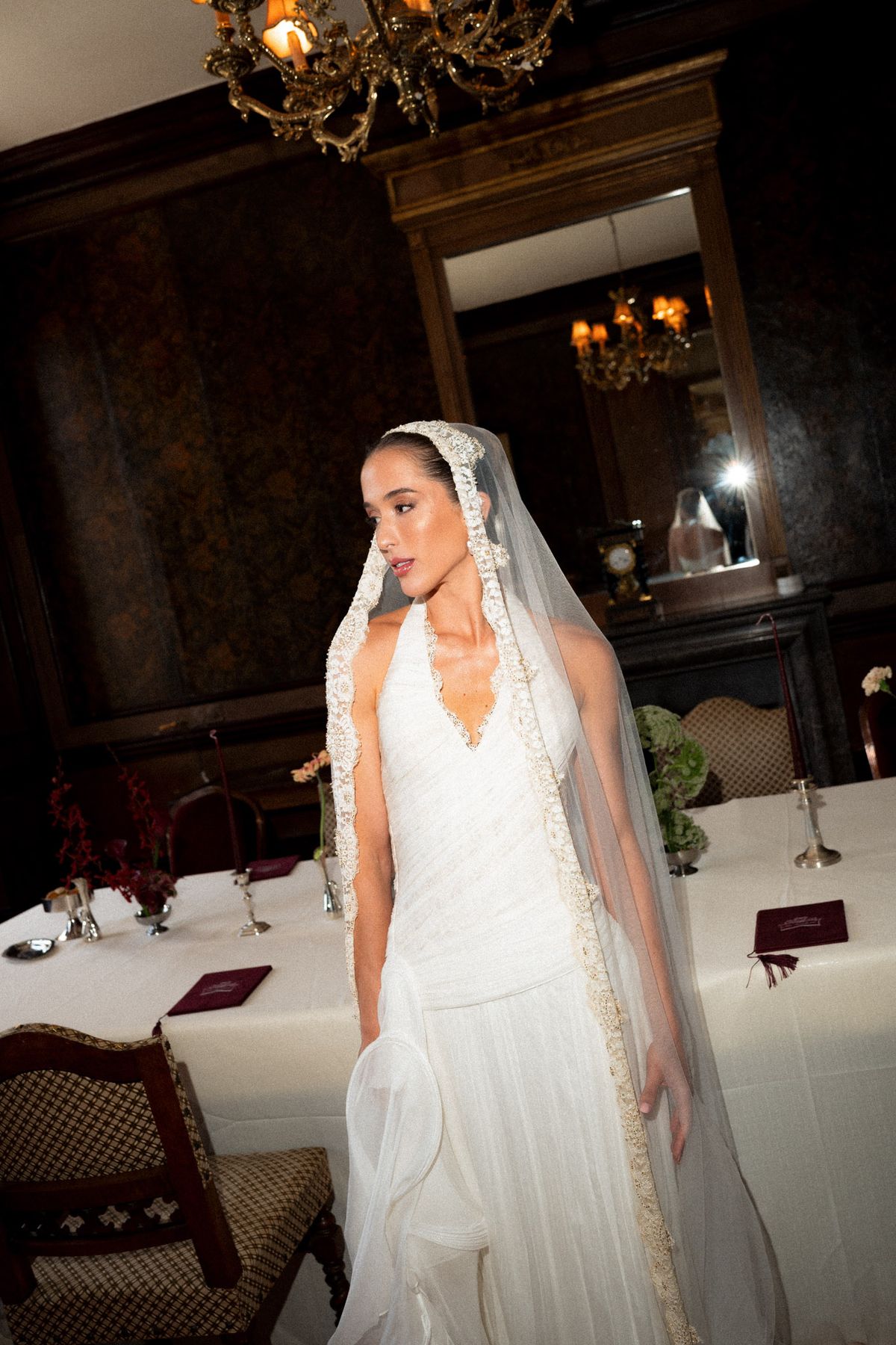 Isadora & Hugo — the bride in her veil in the chateau dining room, spring wedding in Nouvelle-Aquitaine