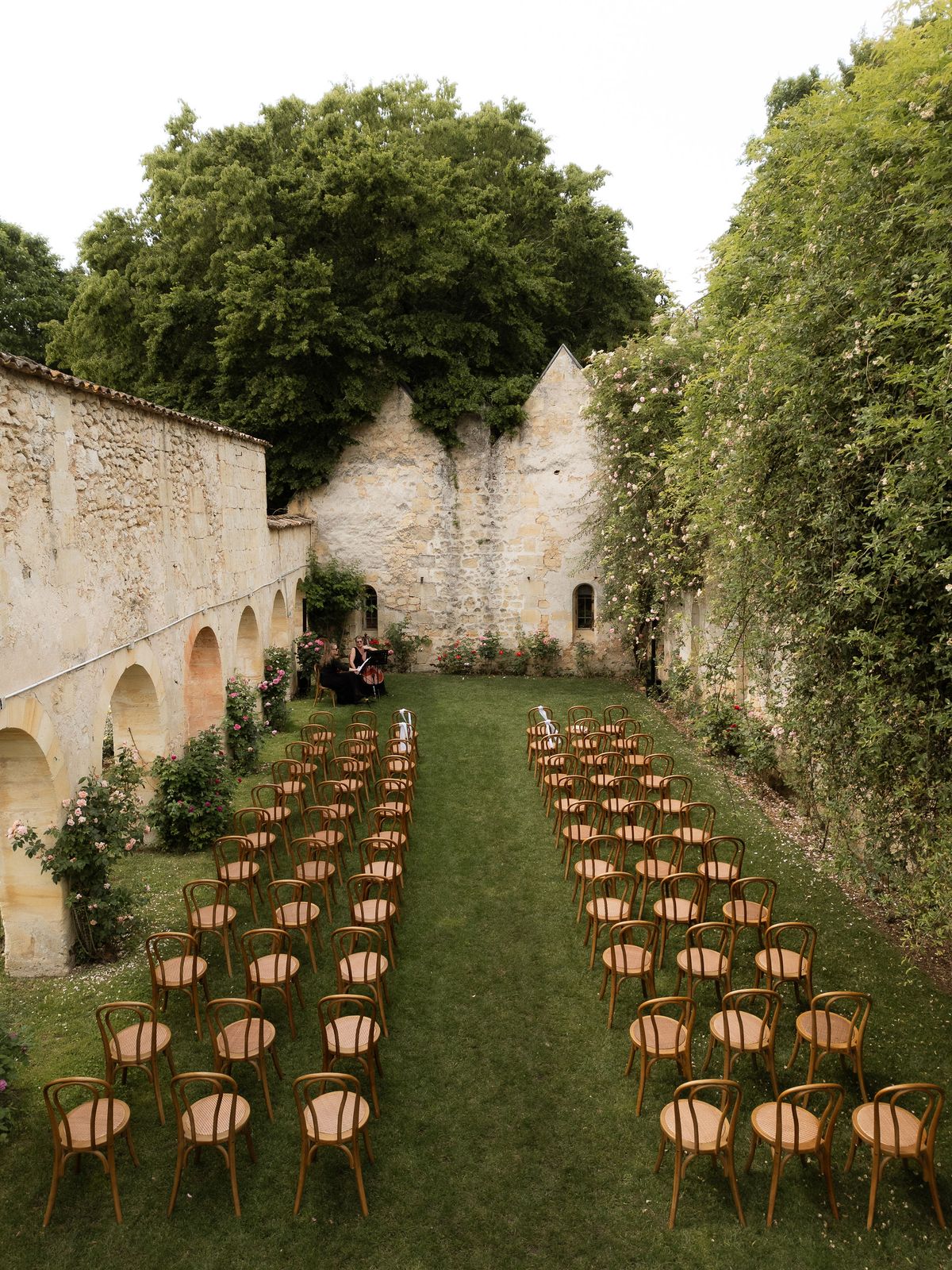 An aerial view of the empty ceremony aisle lined with wooden chairs