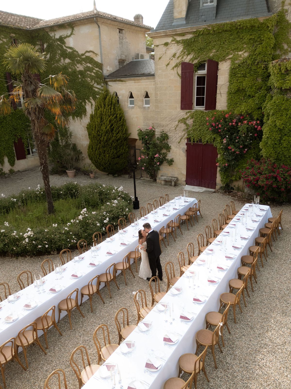 An aerial view of the long reception table set on the château lawn