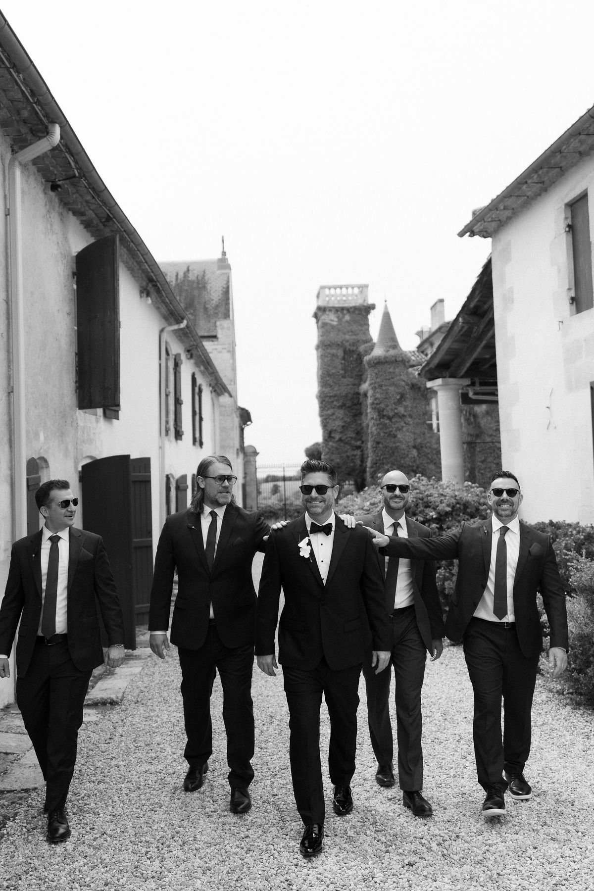 JD's groomsmen walking together through the château grounds