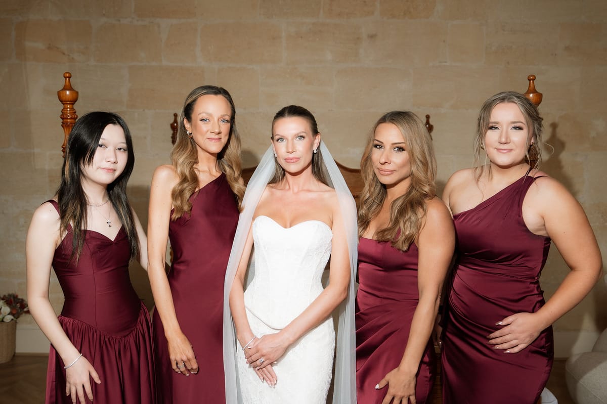 Jori with two bridesmaids in burgundy gowns