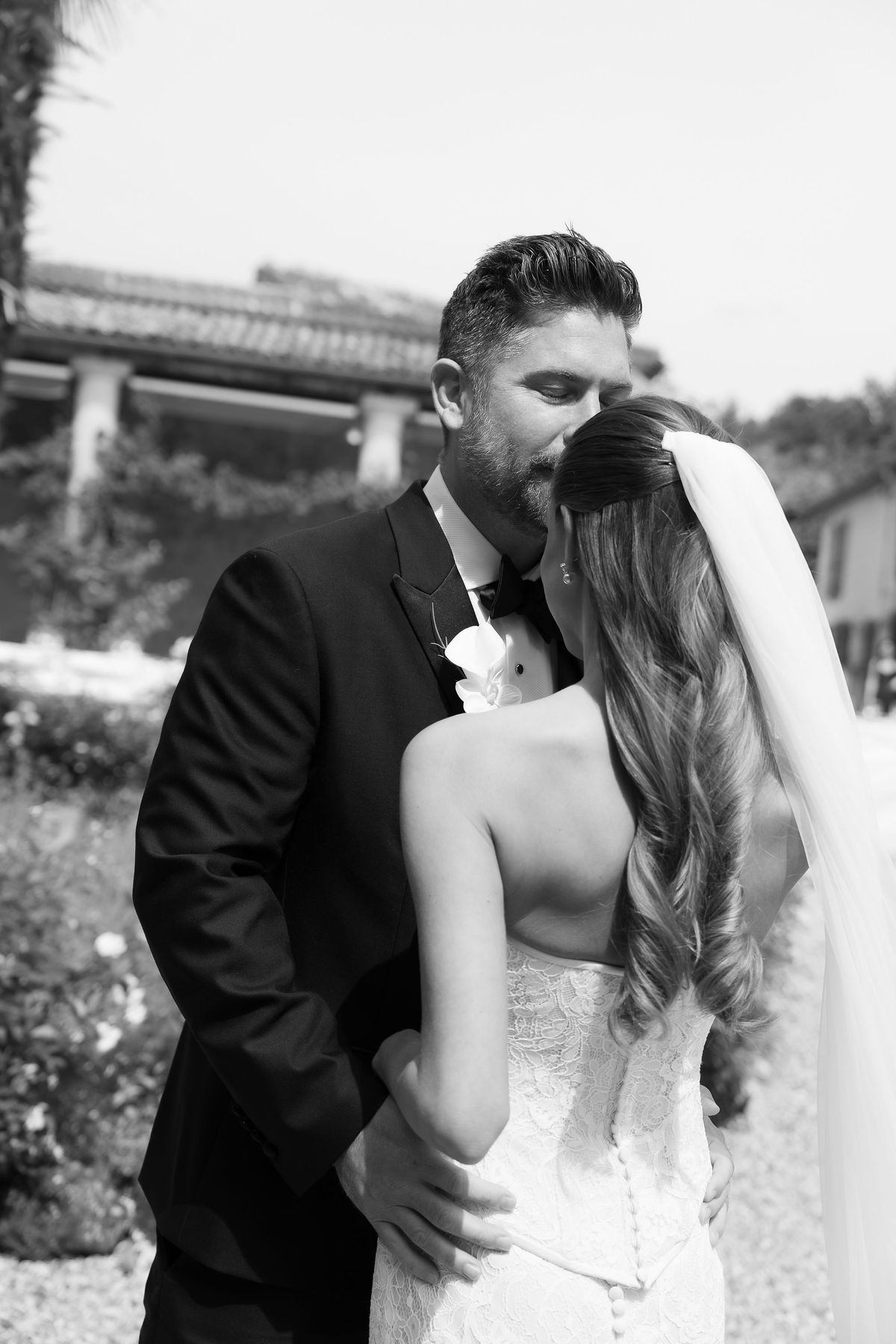 A black-and-white photo of Jori and JD kissing, her hair worn loose