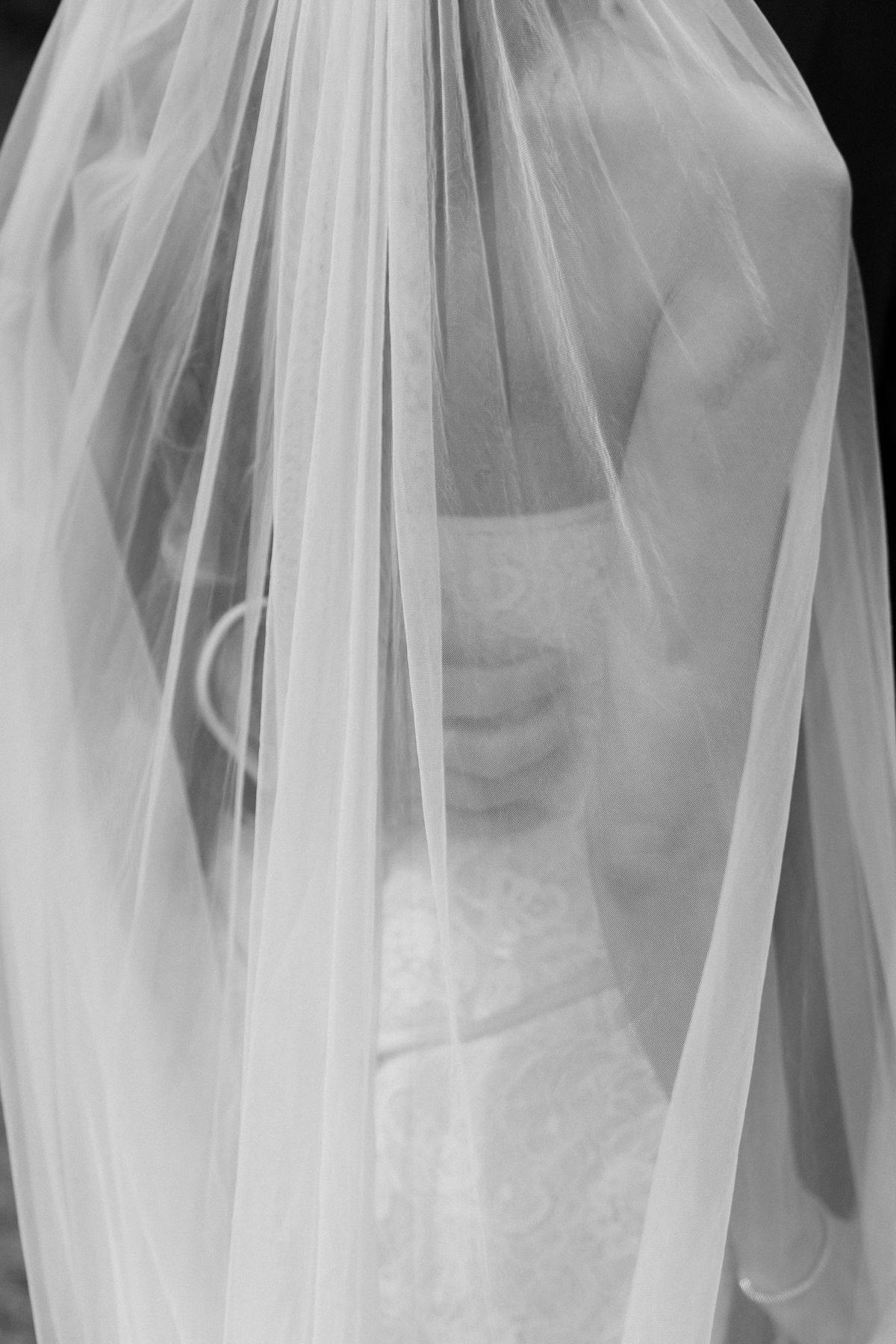 A black-and-white detail of Jori's veil against her gown