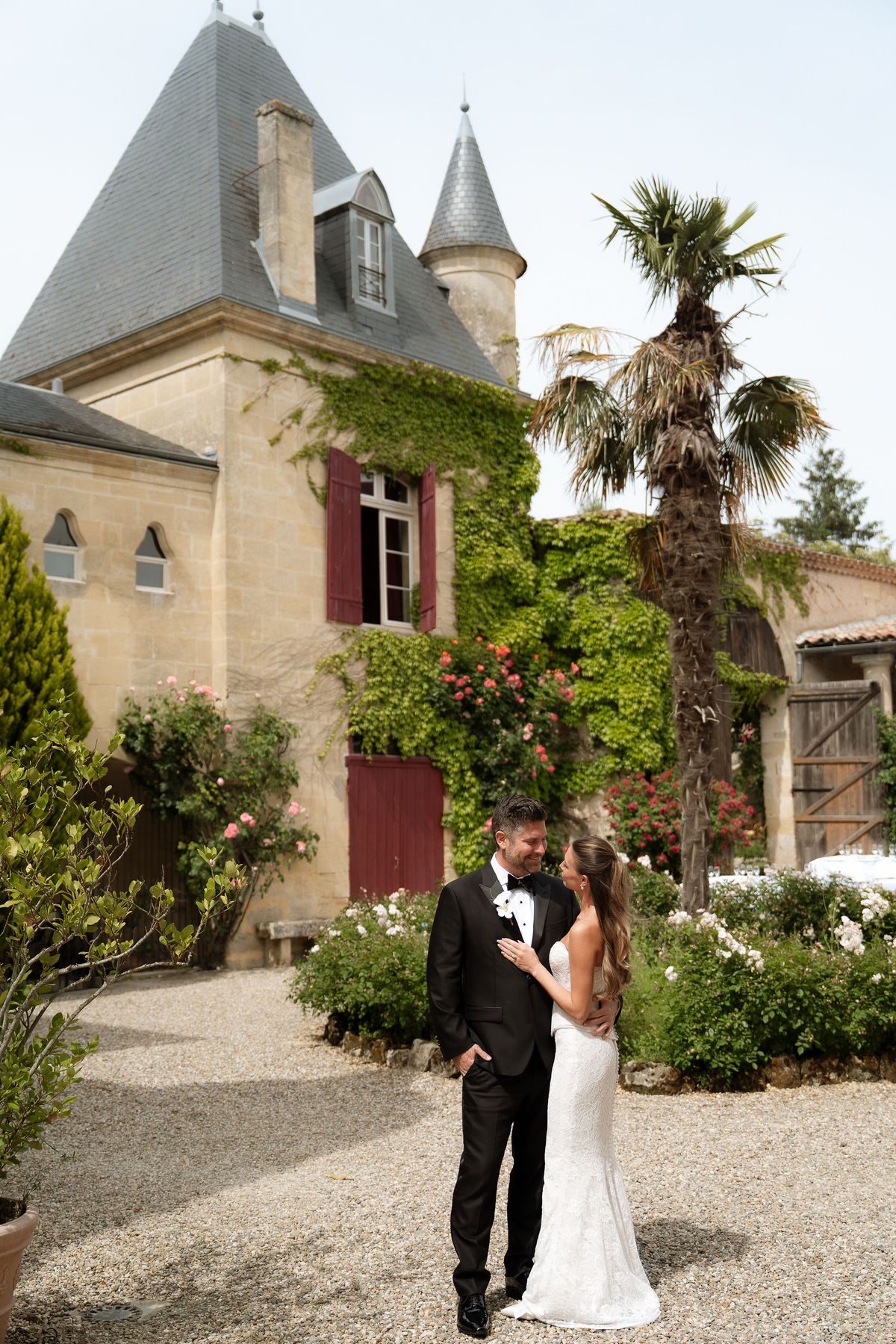 Jori and JD embracing outdoors beneath a cloudy sky