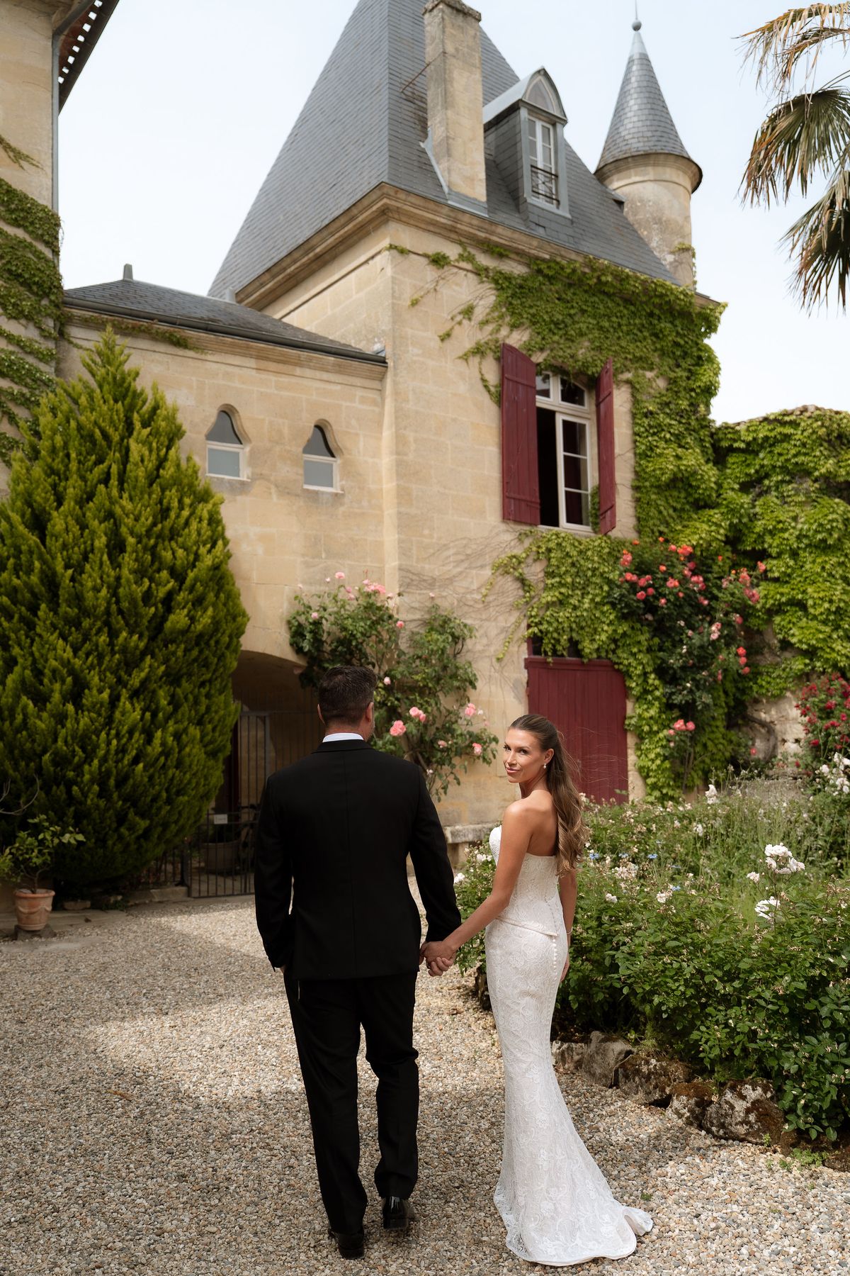 Jori and JD walking away from the camera down a gravel path