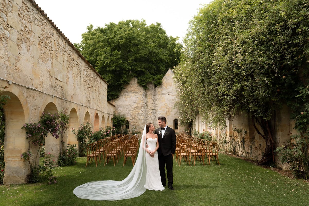 Jori and JD standing together on the ceremony lawn