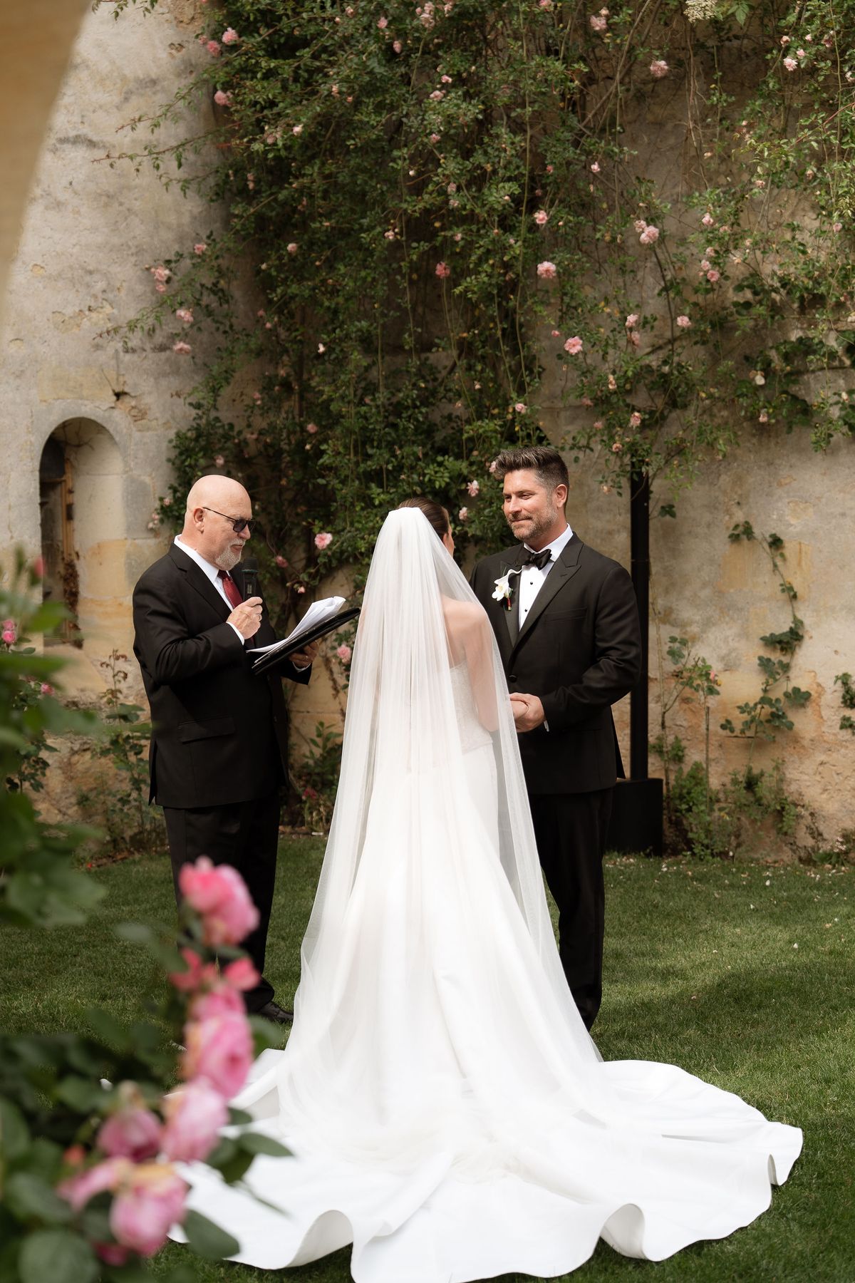 Jori and JD exchanging vows with the officiant
