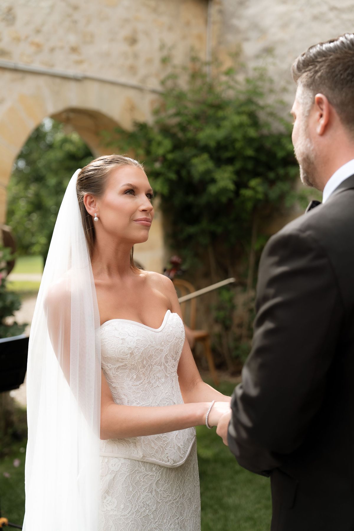 Jori and JD close together, Jori wearing an off-the-shoulder lace gown