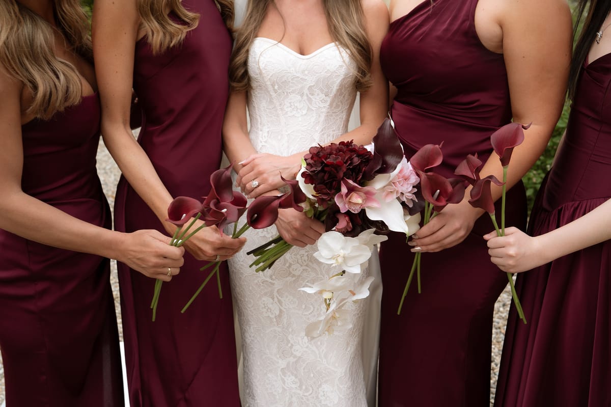 Close-up of Jori's bouquet of burgundy calla lilies and white orchids