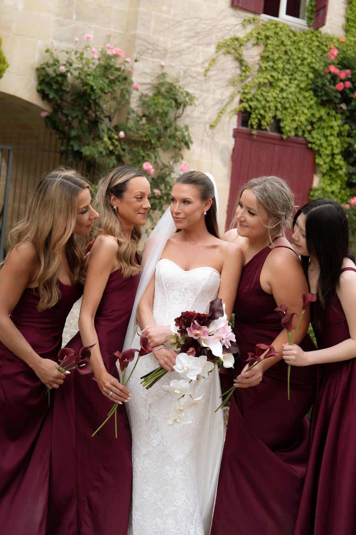 Jori's bridesmaids walking together carrying their bouquets