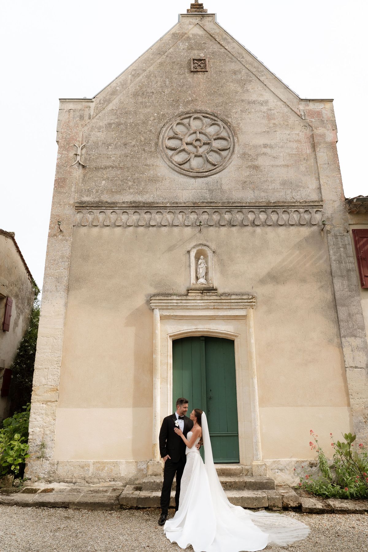 Jori and JD standing together outside the stone chapel entrance