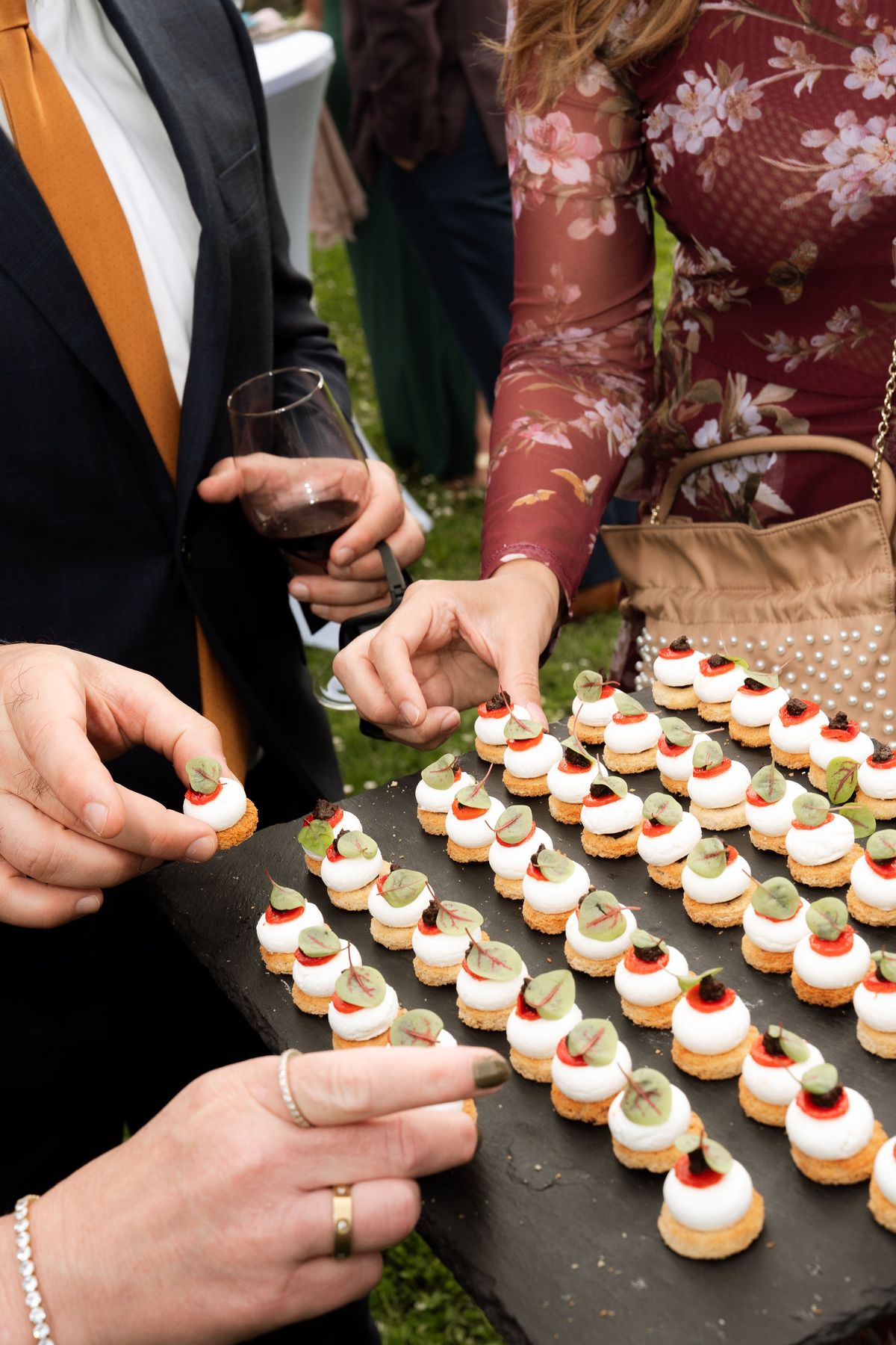 A guest selecting canapés from a tray during cocktail hour