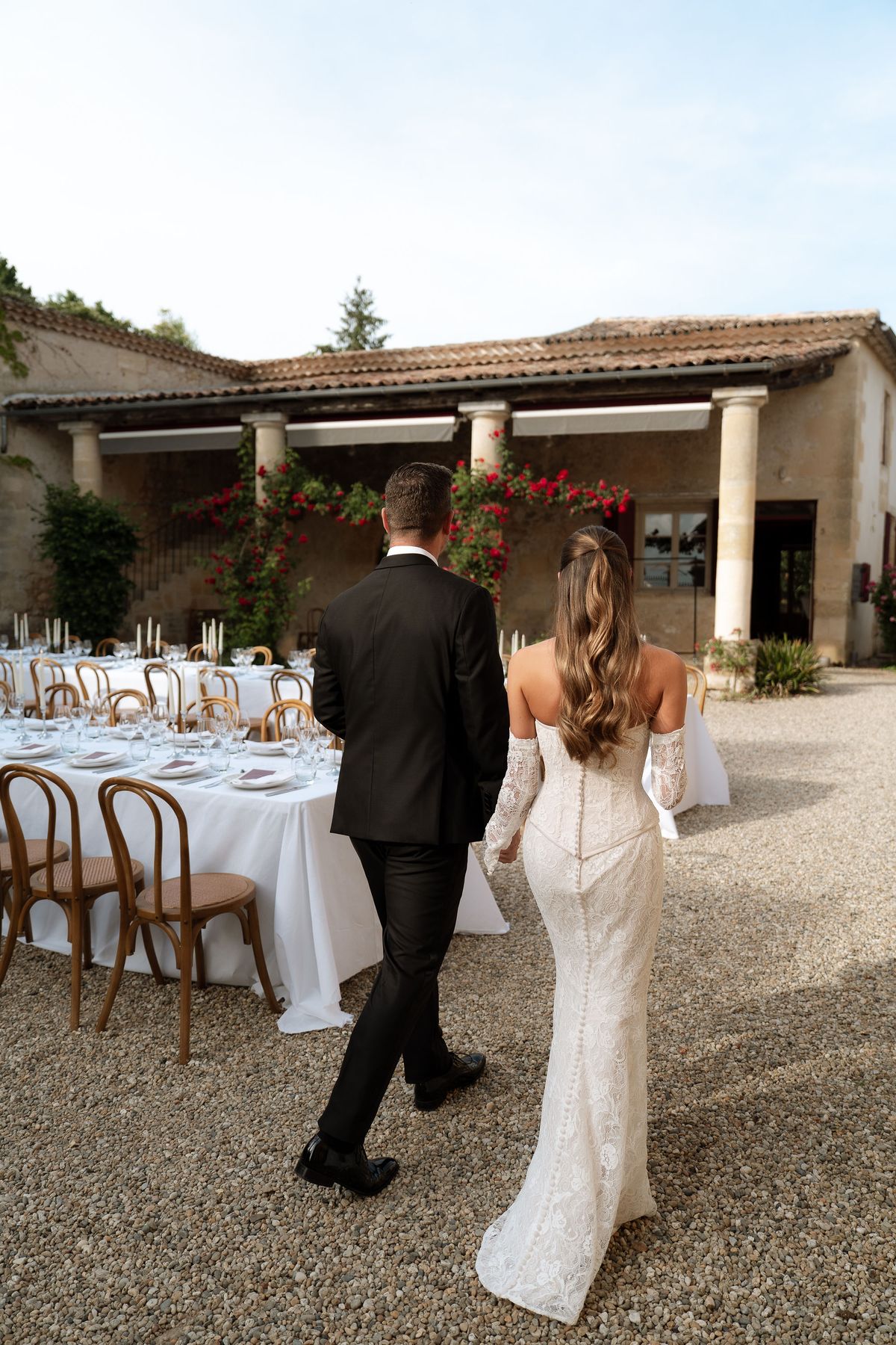 Jori walking past a set table on the château terrace