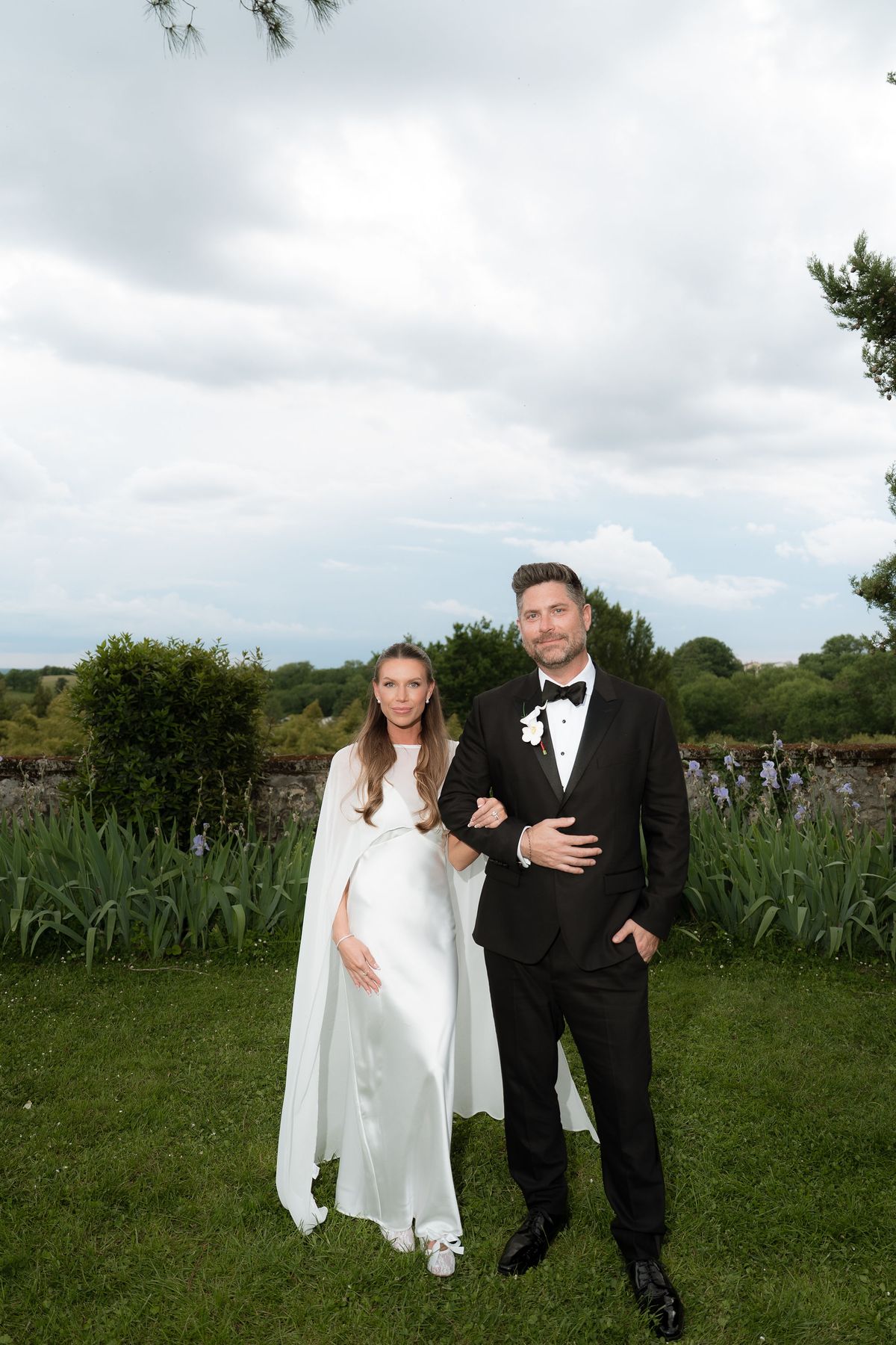 Jori and JD standing together on the lawn under an overcast sky