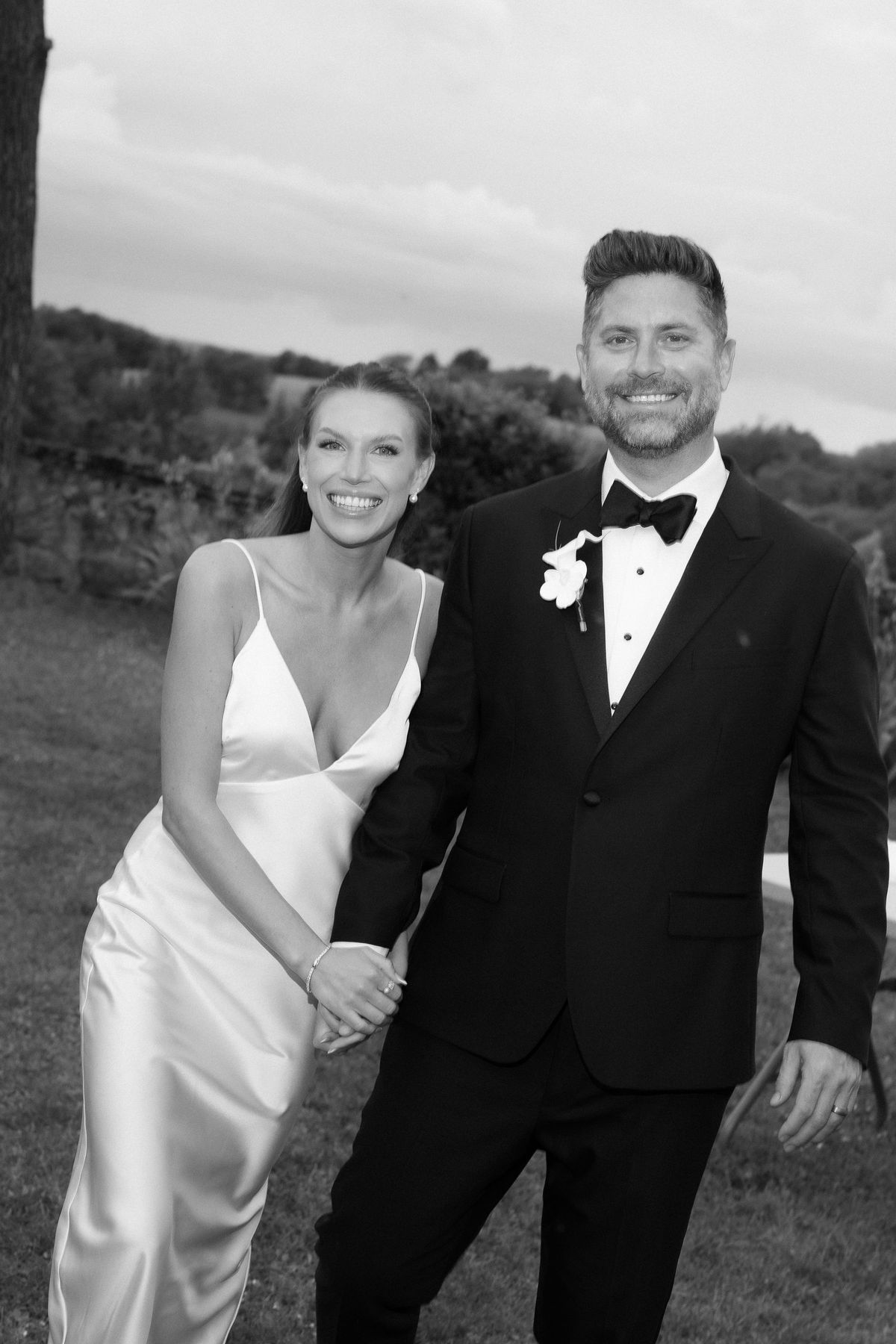 Jori and JD walking together with her veil trailing behind