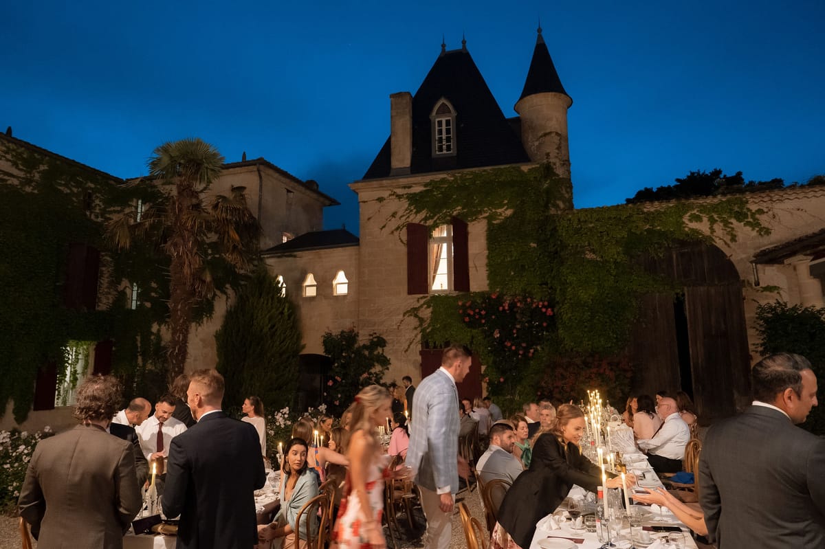 Château Sentout lit up at dusk during the reception