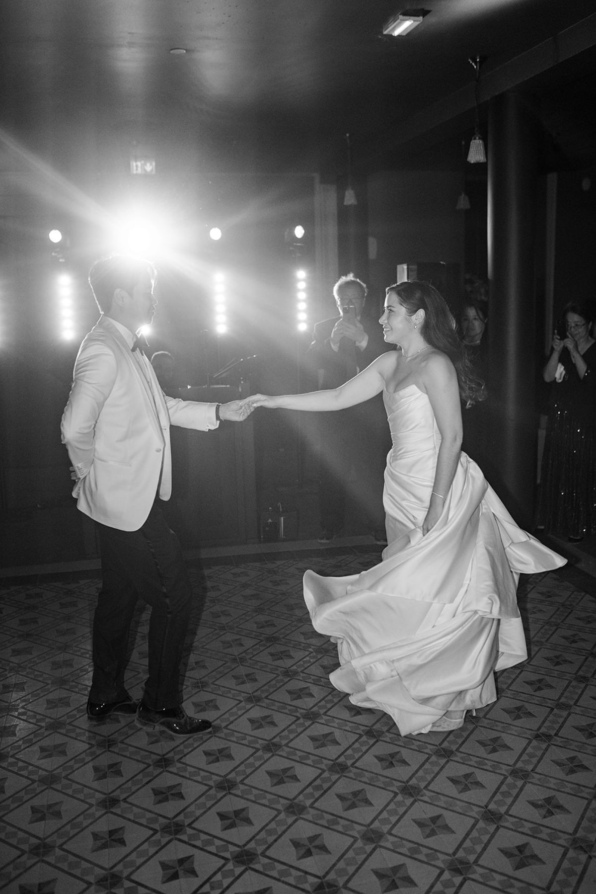Black and white view of Carina and Stefan dancing under the lights at the afterparty