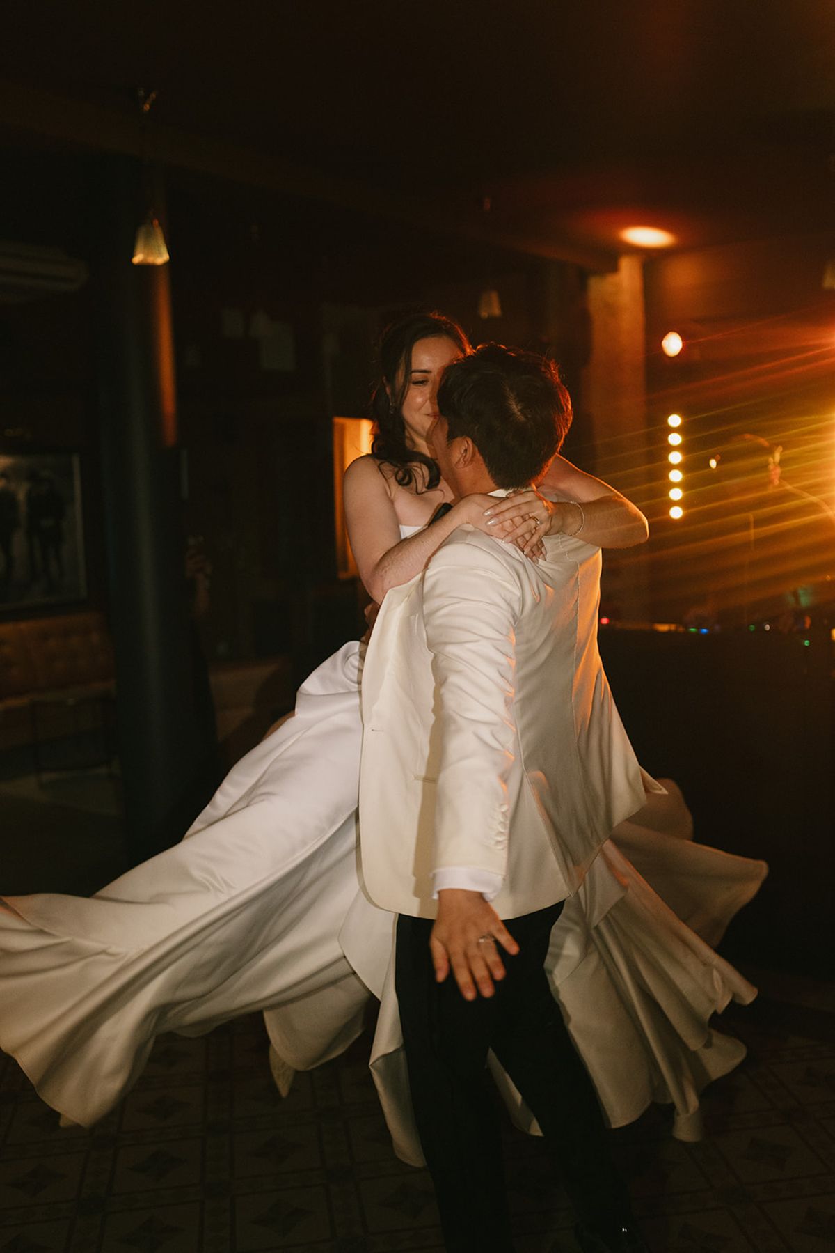 Stefan lifting Carina as they spin on the afterparty dance floor