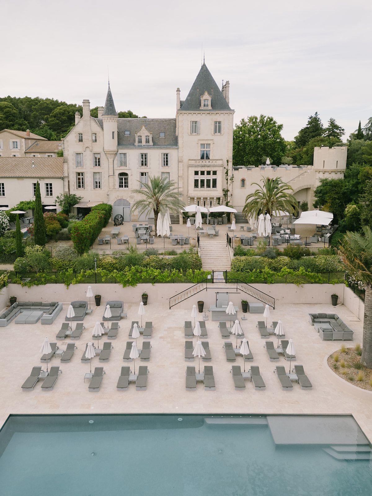 Aerial view of Château les Carrasses above its formal gardens and swimming pool