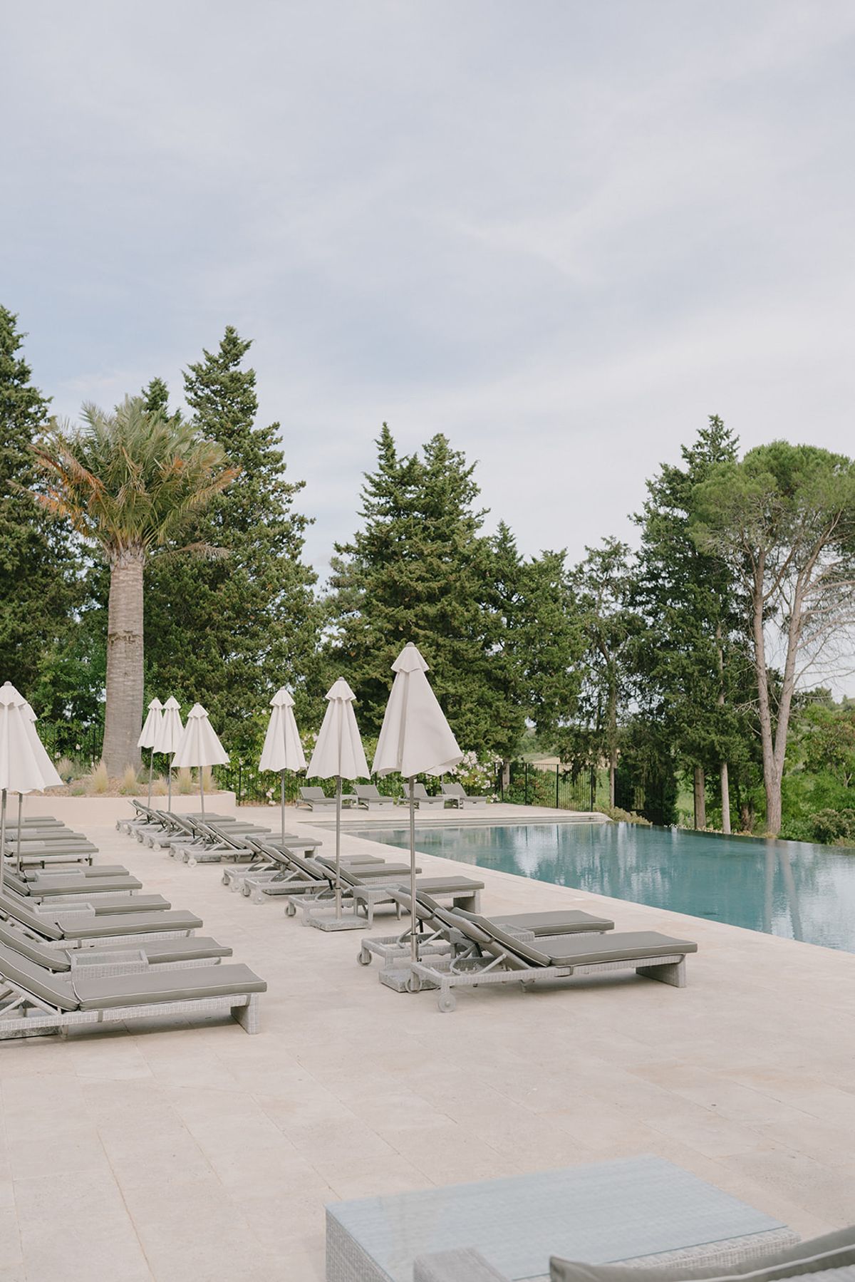 Sun loungers and parasols along the estate's outdoor swimming pool