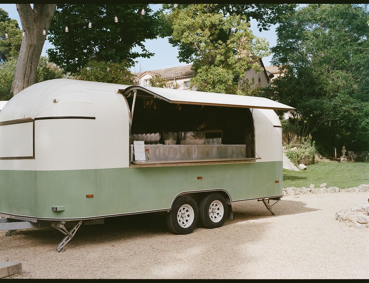 A vintage cream and green trailer bar on the grounds at the welcome party the day before