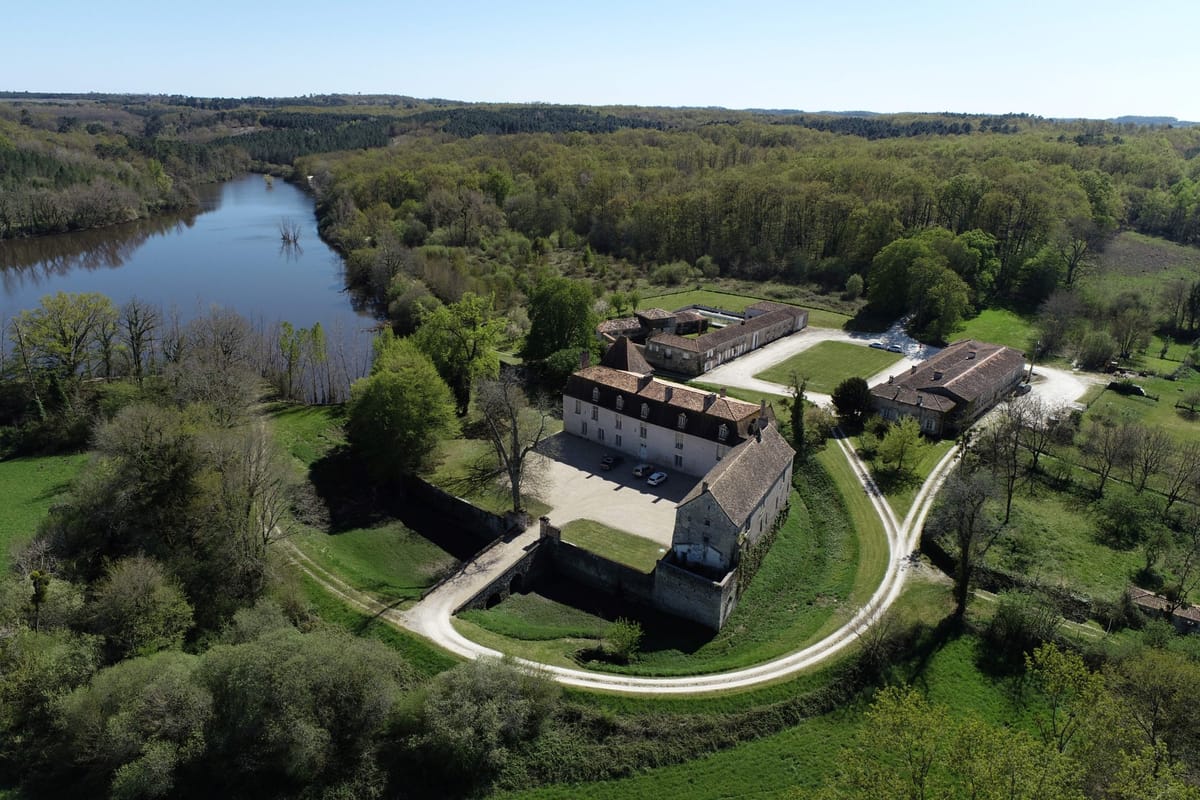 Aerial view of Château de la Faye, its courtyard and the lake within the estate