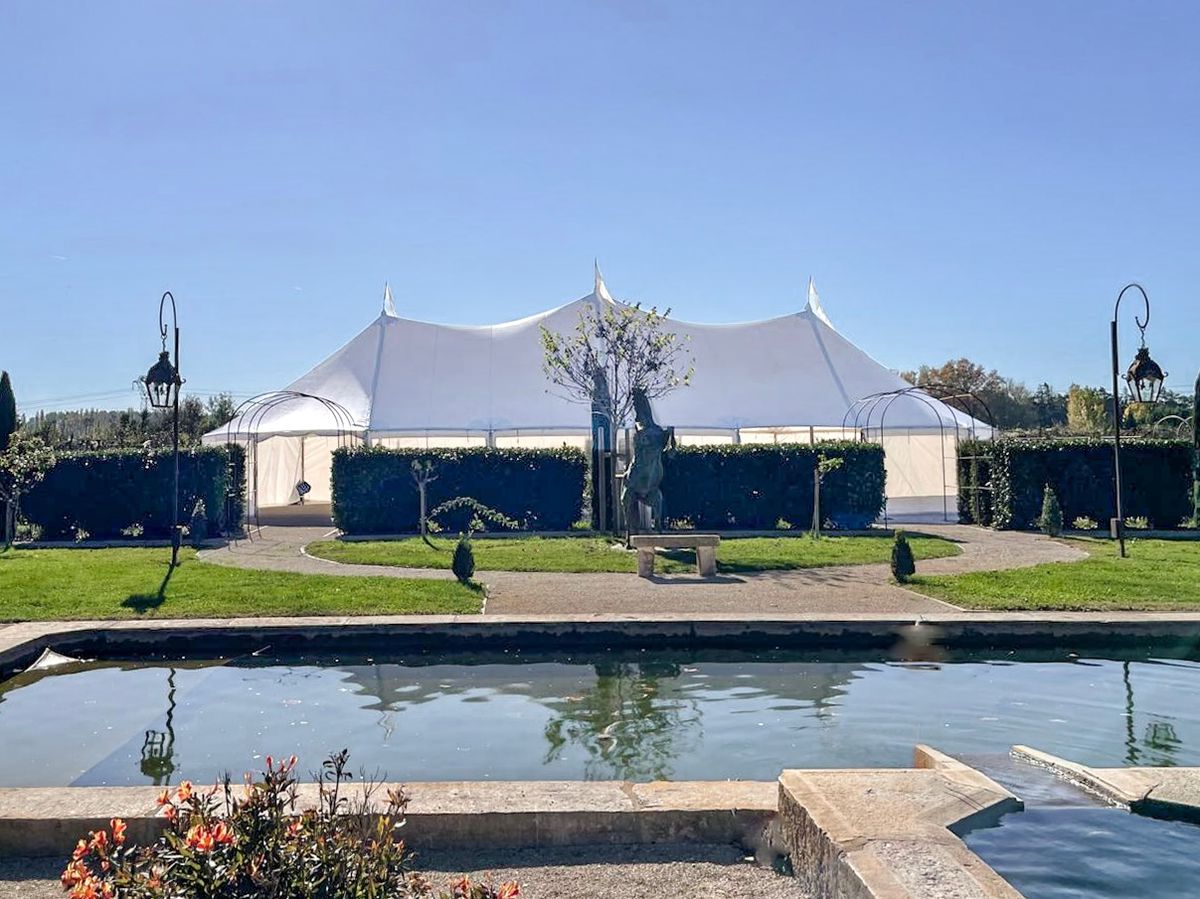 Daytime view of the sailcloth marquee beside the reflecting pool