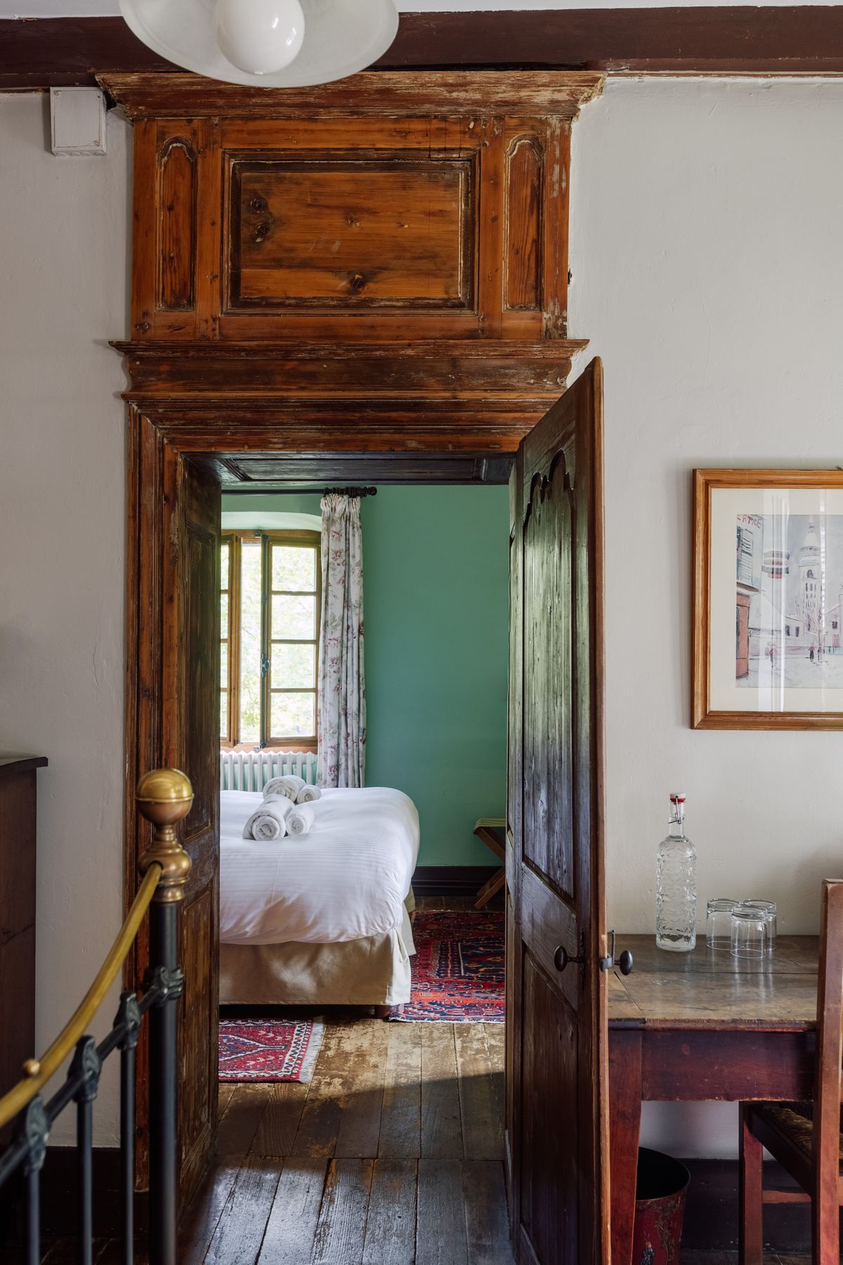 Wooden doorway and staircase opening onto a bedroom