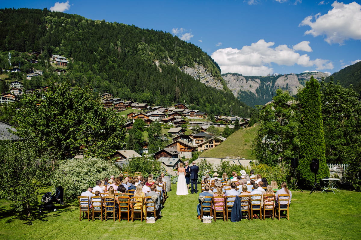 Wedding ceremony in the hotel garden, with Morzine and the mountains behind